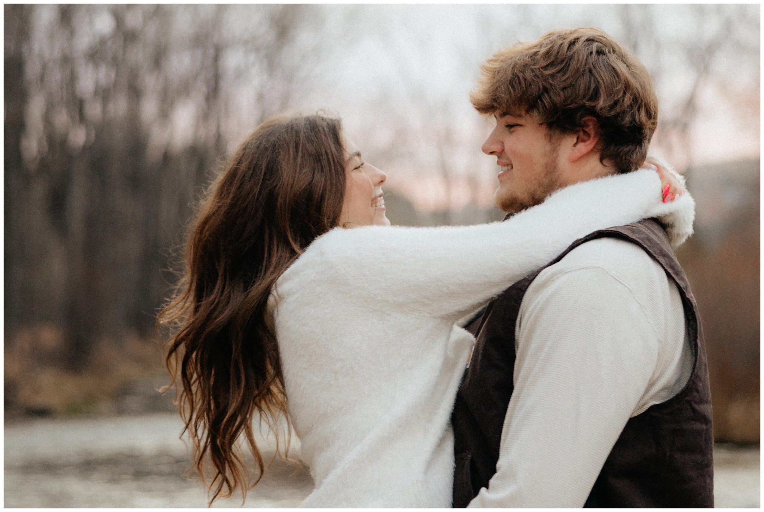 A man spinning a woman around in his arms.