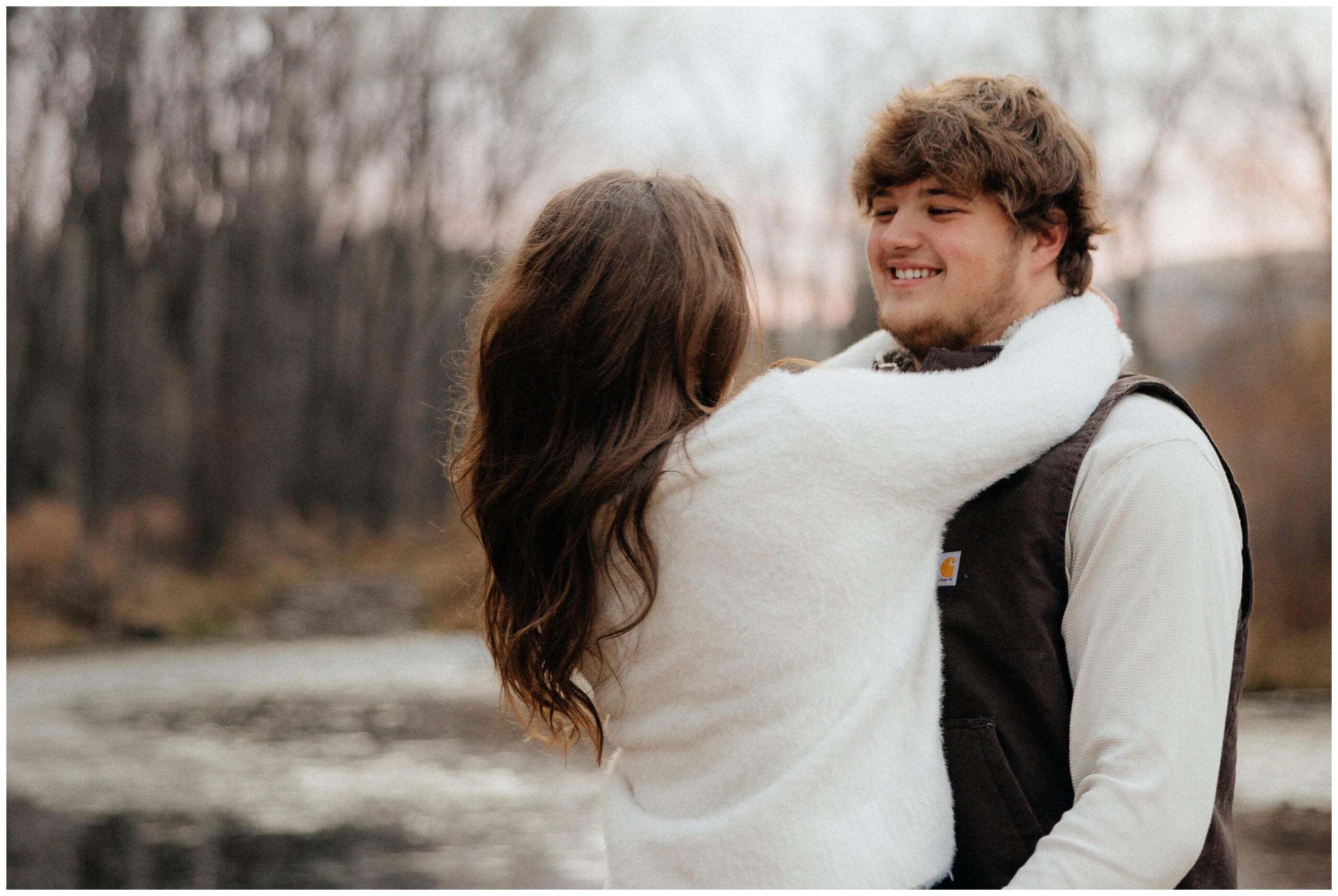 A couple smiling at each other as they spin.