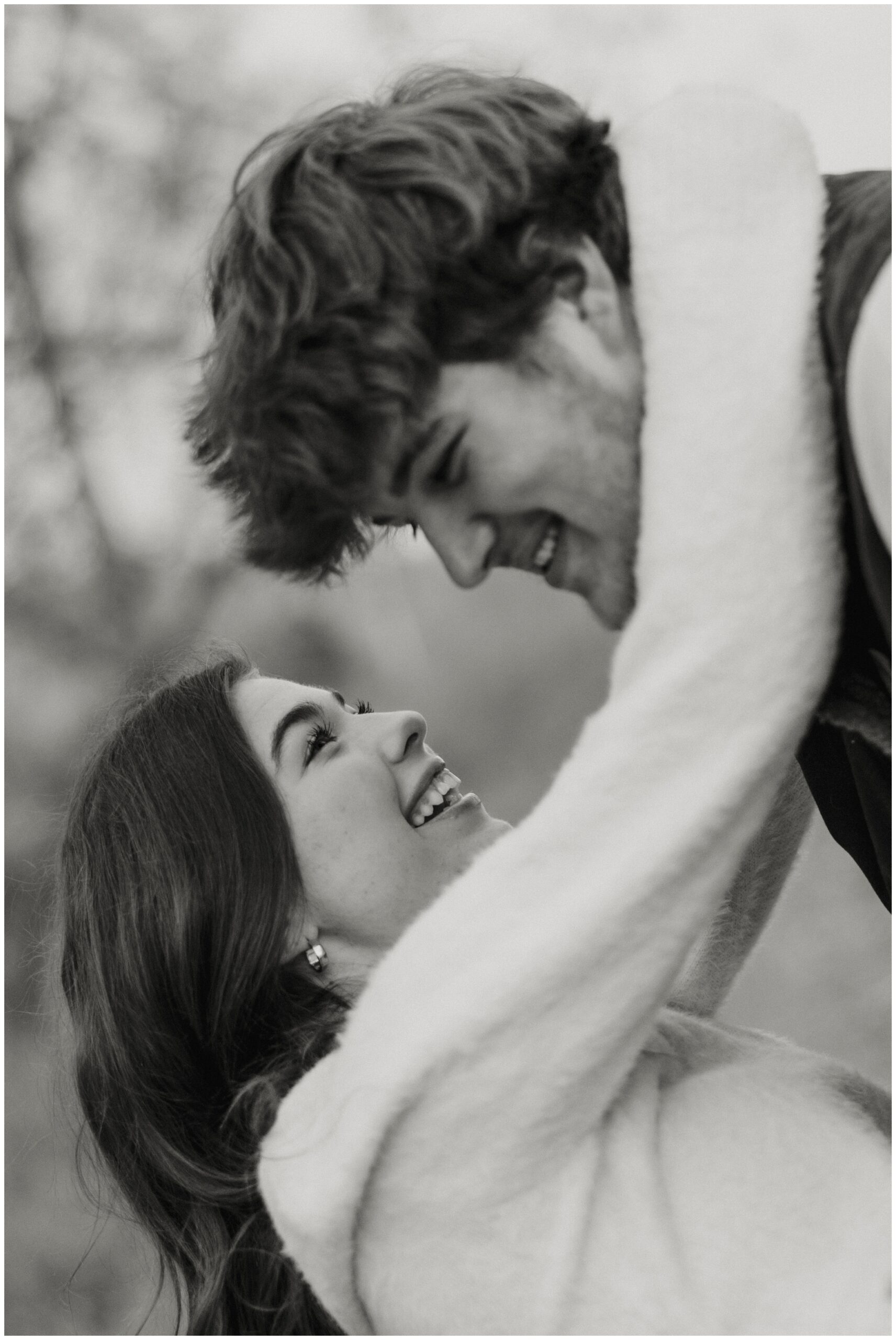 A man dipping a woman and smiling at each other.