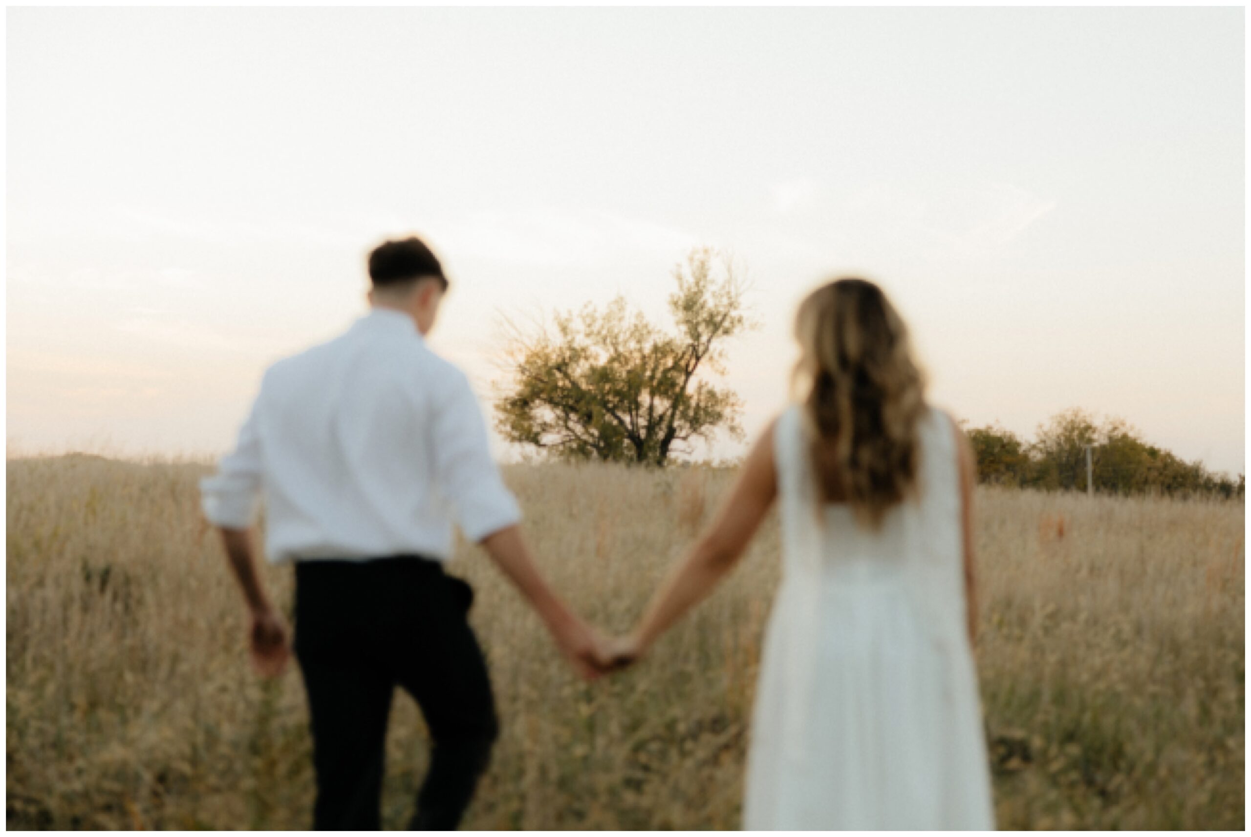 A couple walking toward a tree. This is a fun, trendy, blurred image.