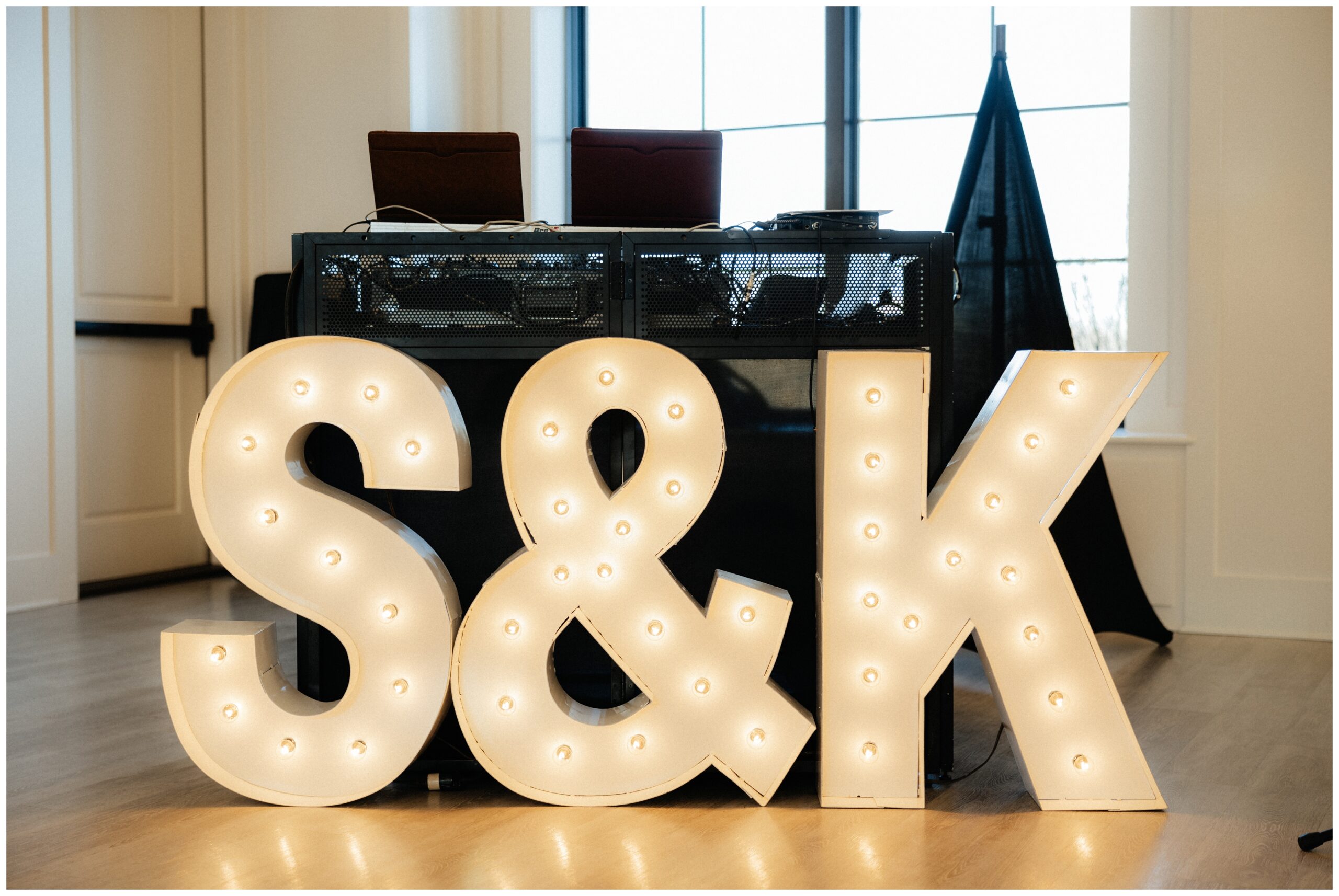 S&K light sign in front of DJ stand.