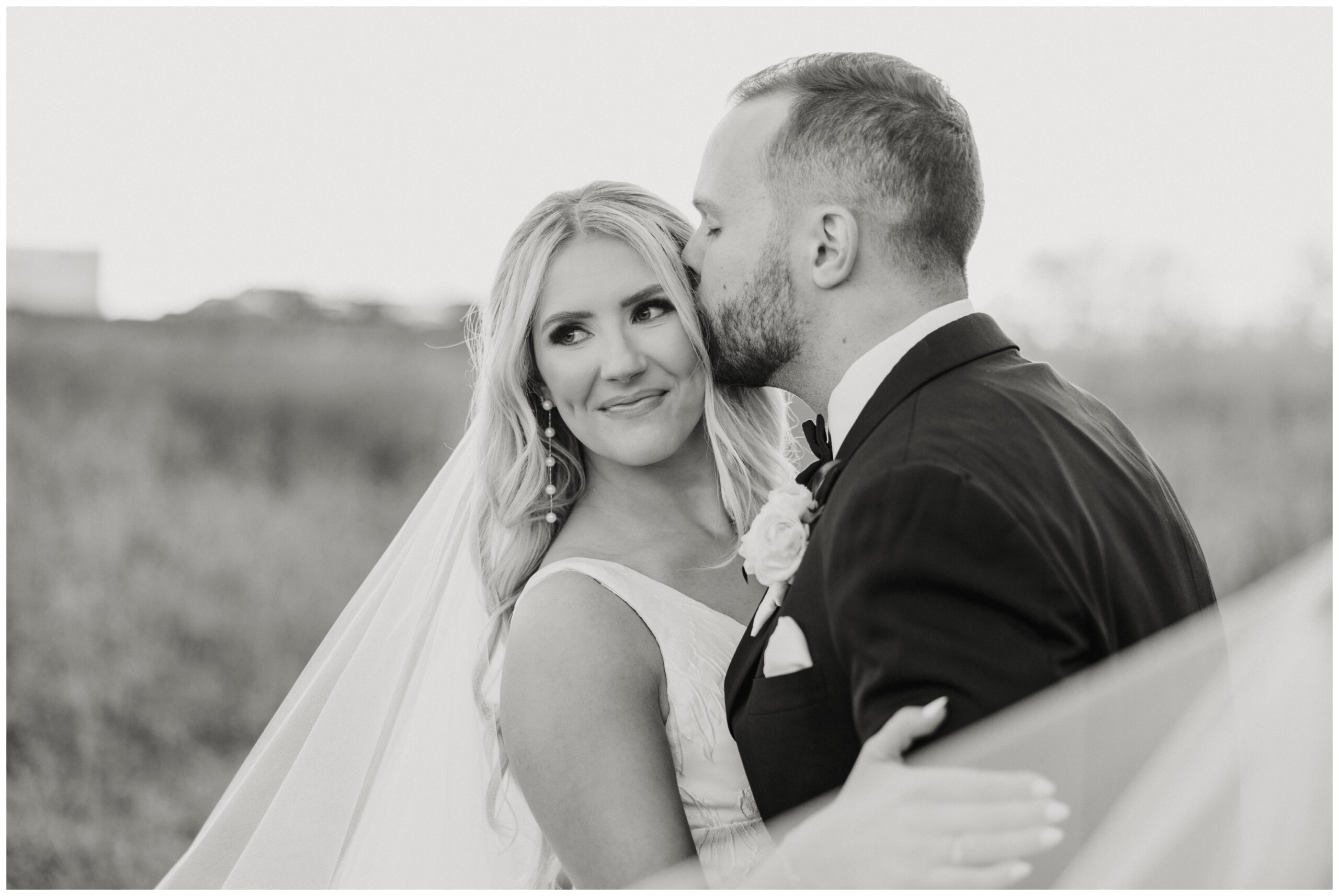 Black and white image of the bride and groom during golden hour.