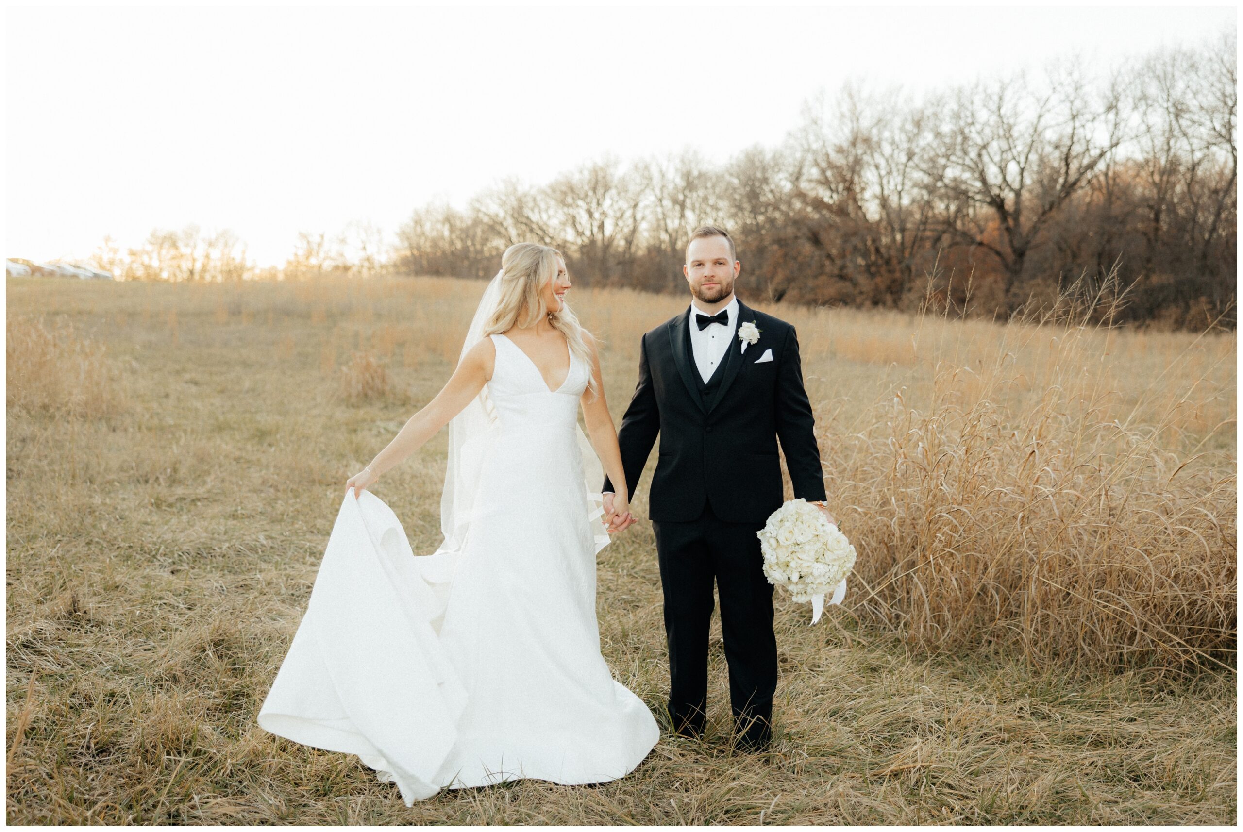 The bride and groom standing side by side during portraits.