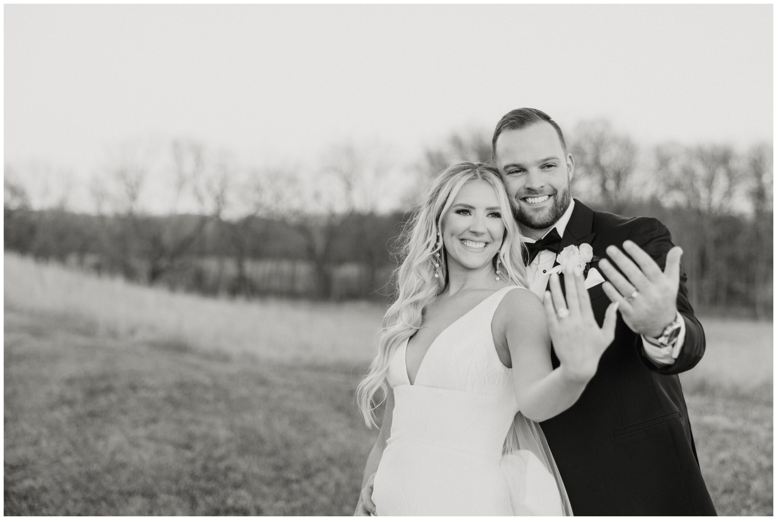 Bride and groom holding out their hands to show off their wedding rings.