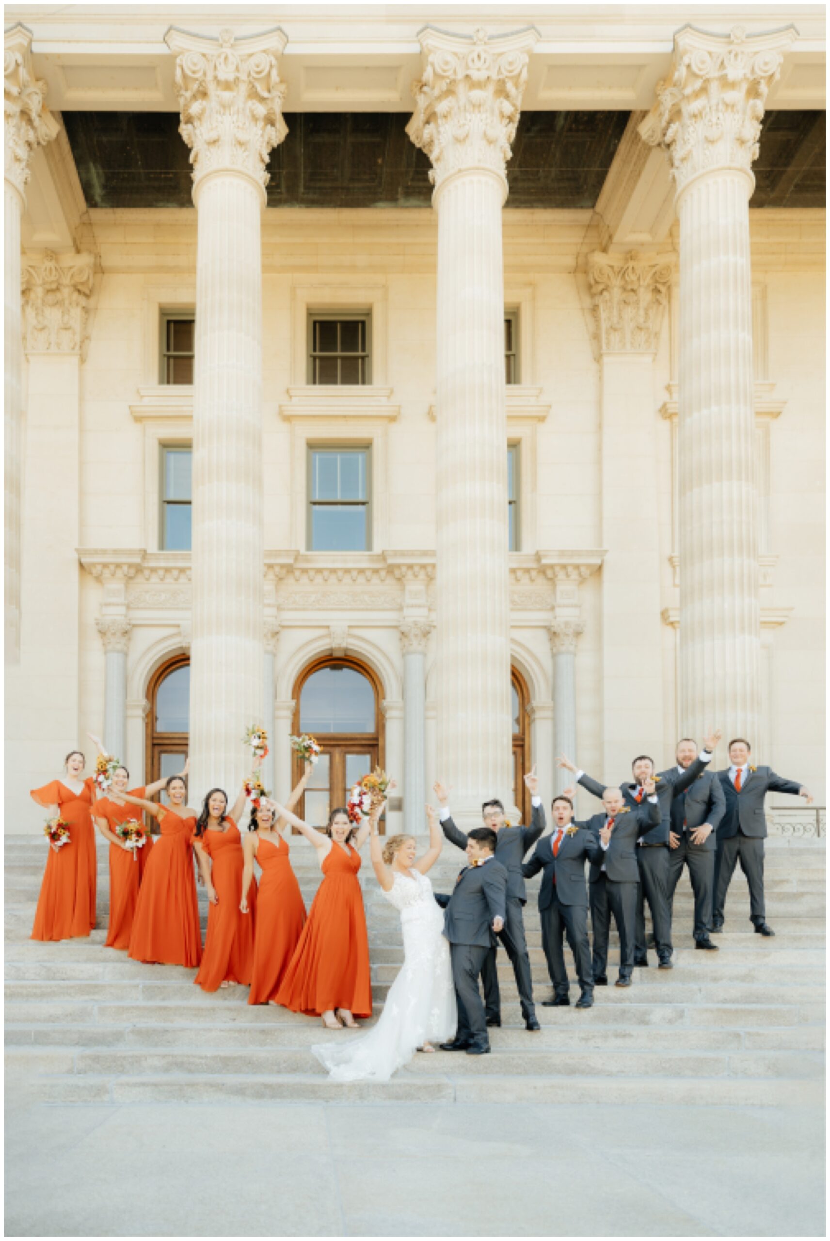 Bridal party on the capital building stairs celebrating.