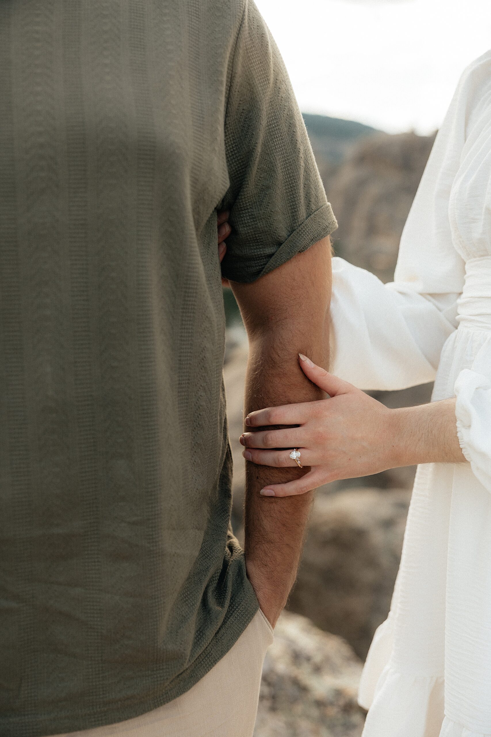 Emily rested her hand on Harrison's arm, her engagement ring sparkling in the sunlight.