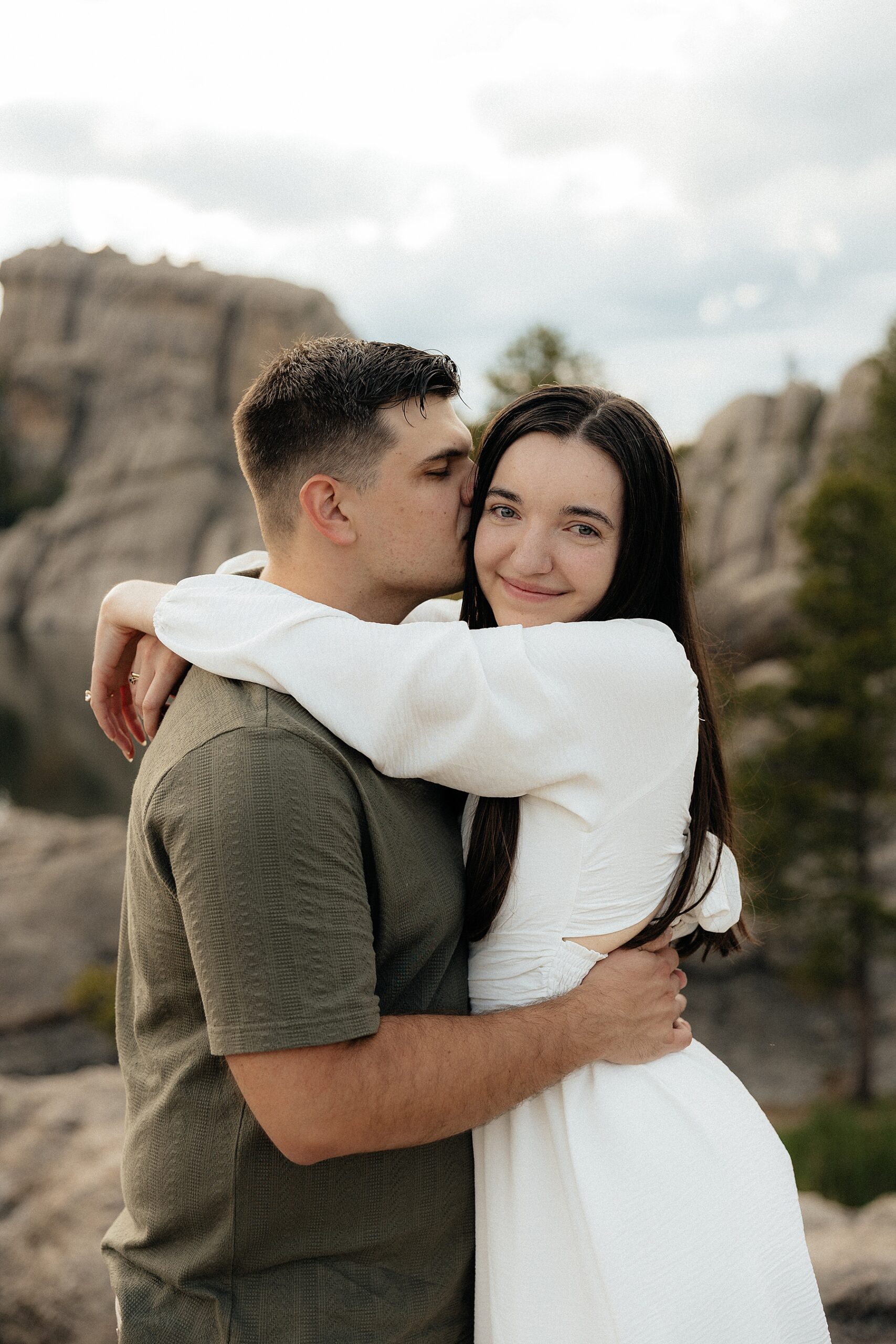 Harrison kissing Emily's cheek.