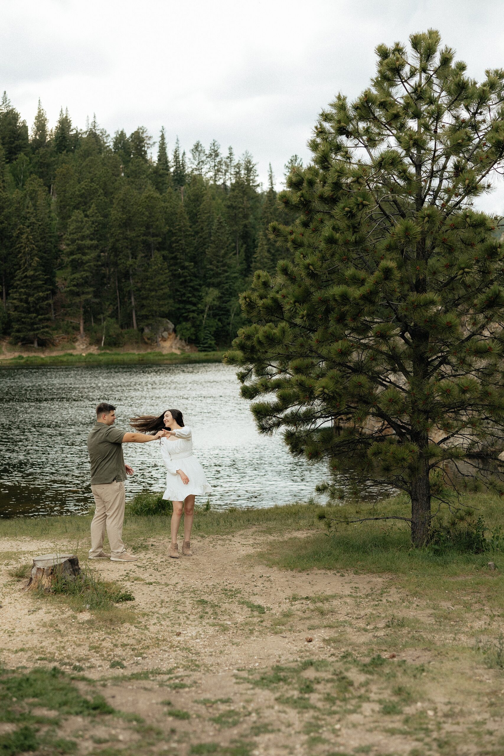 Harrison twirling Emily with a beautiful view of the lake behind them.
