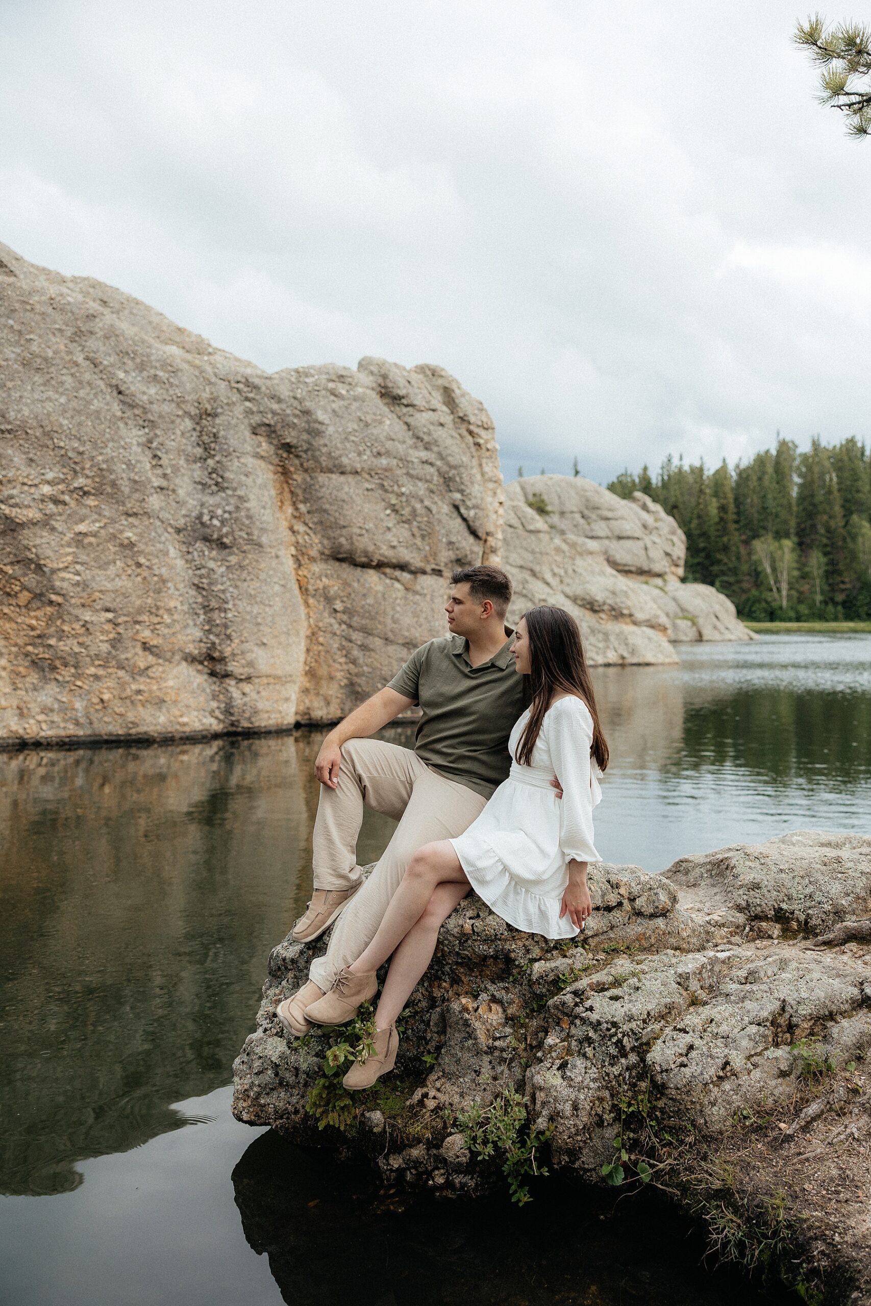 Emily and Harrison sitting on a rock in the Lake.