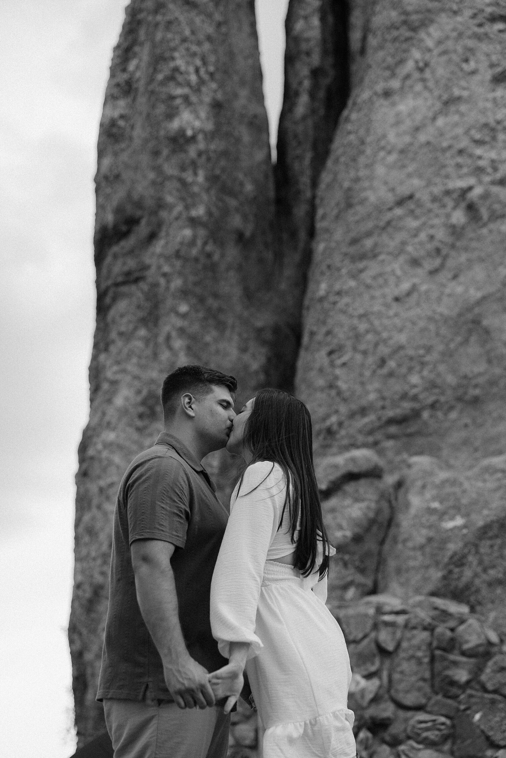Emily + Harrison kissing in front of the Needle's Eye in Custer, South Dakota.