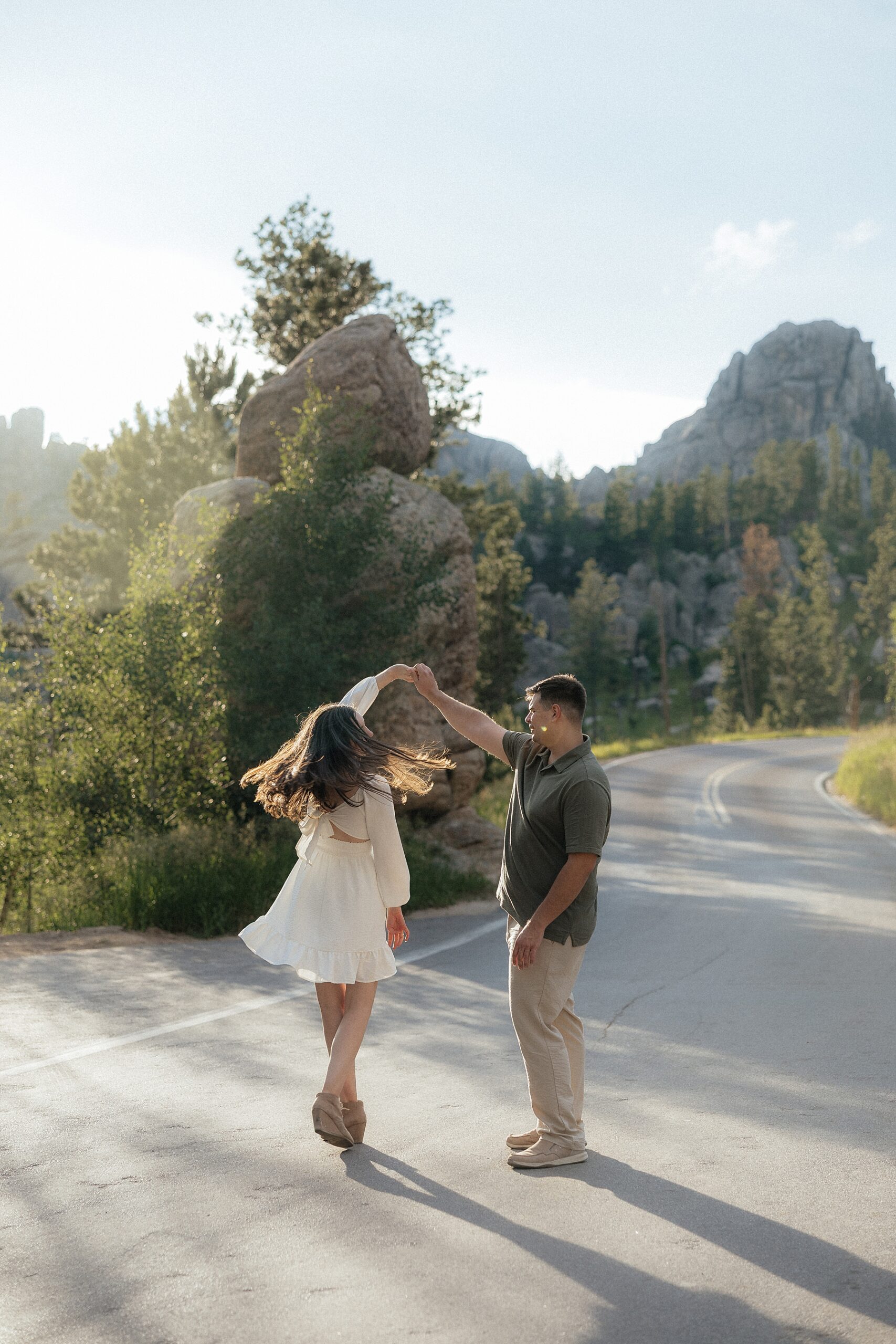 Harrison spinning Emily on Needle's Highway in Custer, South Dakota.