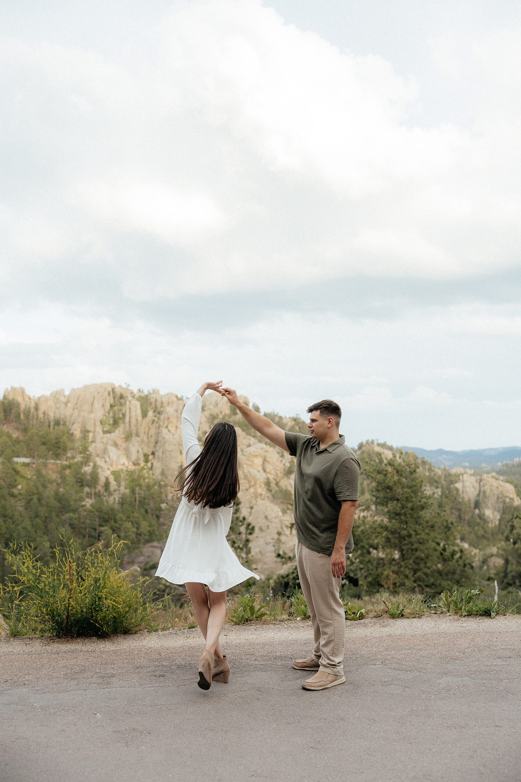 Harrison spinning Emily on Needle's Highway at their Black Hills engagement Session.