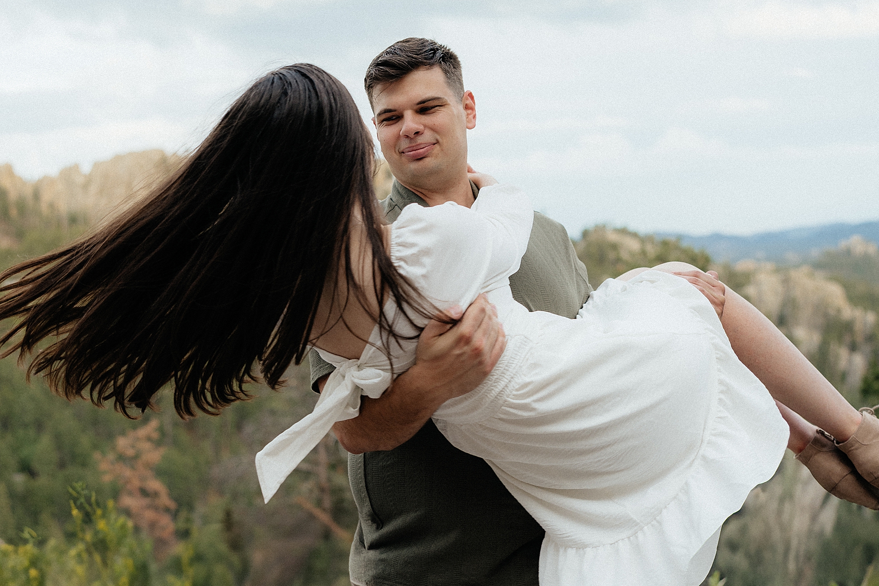 Harrison carrying Emily bridal style (or what he calls princess style — so cute!) while spinning her around.