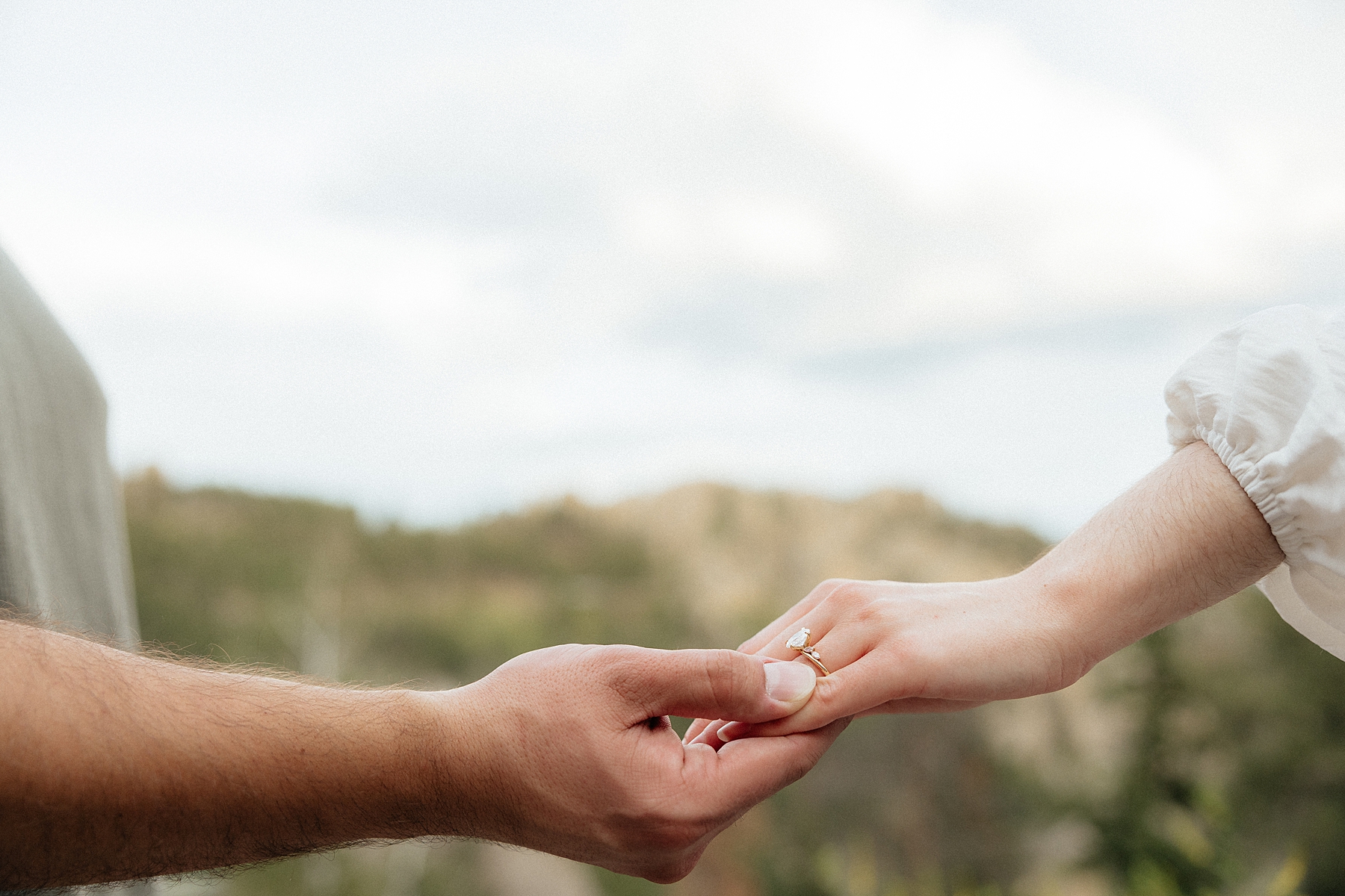 Emily and Harrison holding hands.