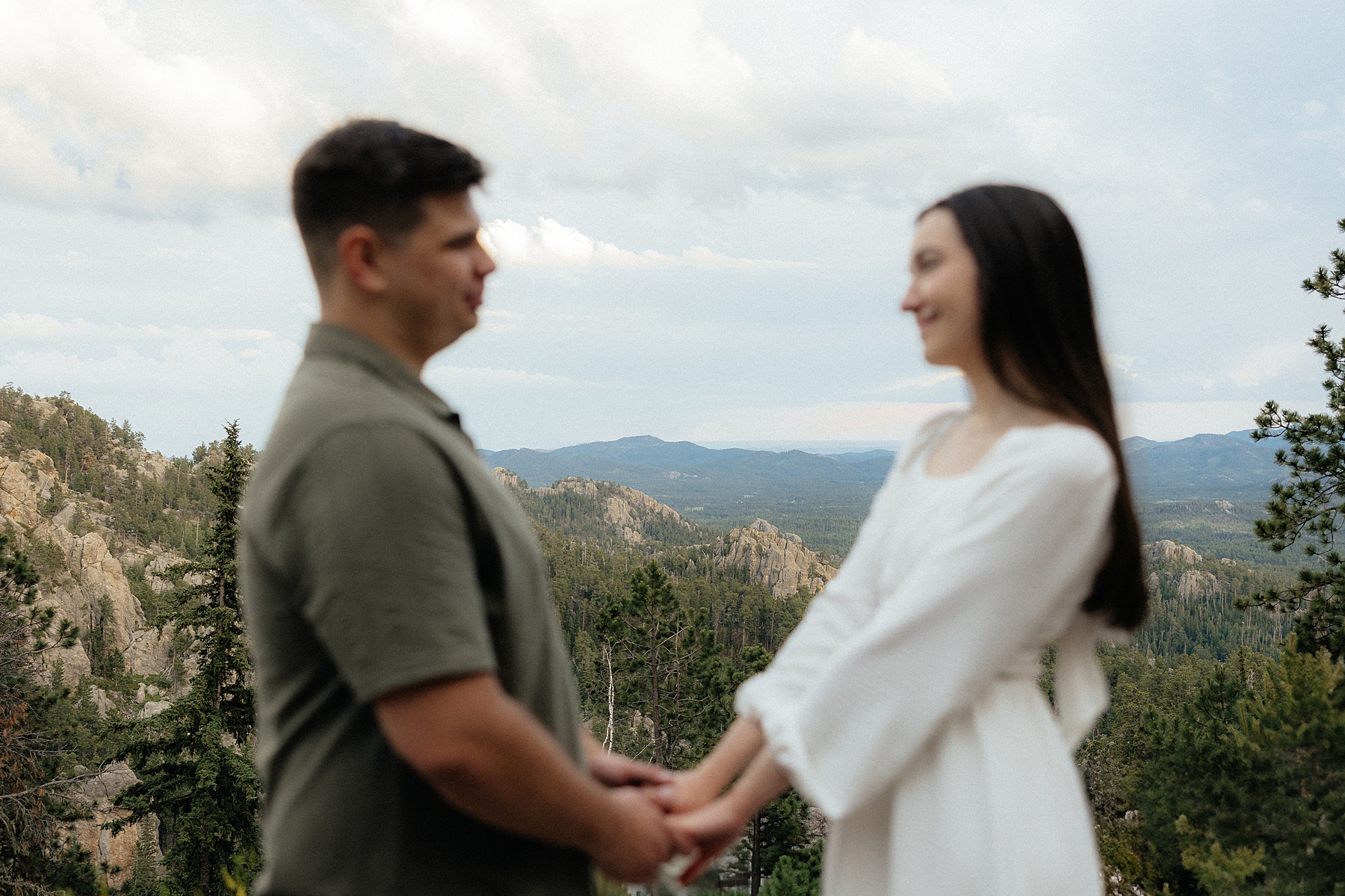 Emily and Harrison with a view of the Black Hills behind them.