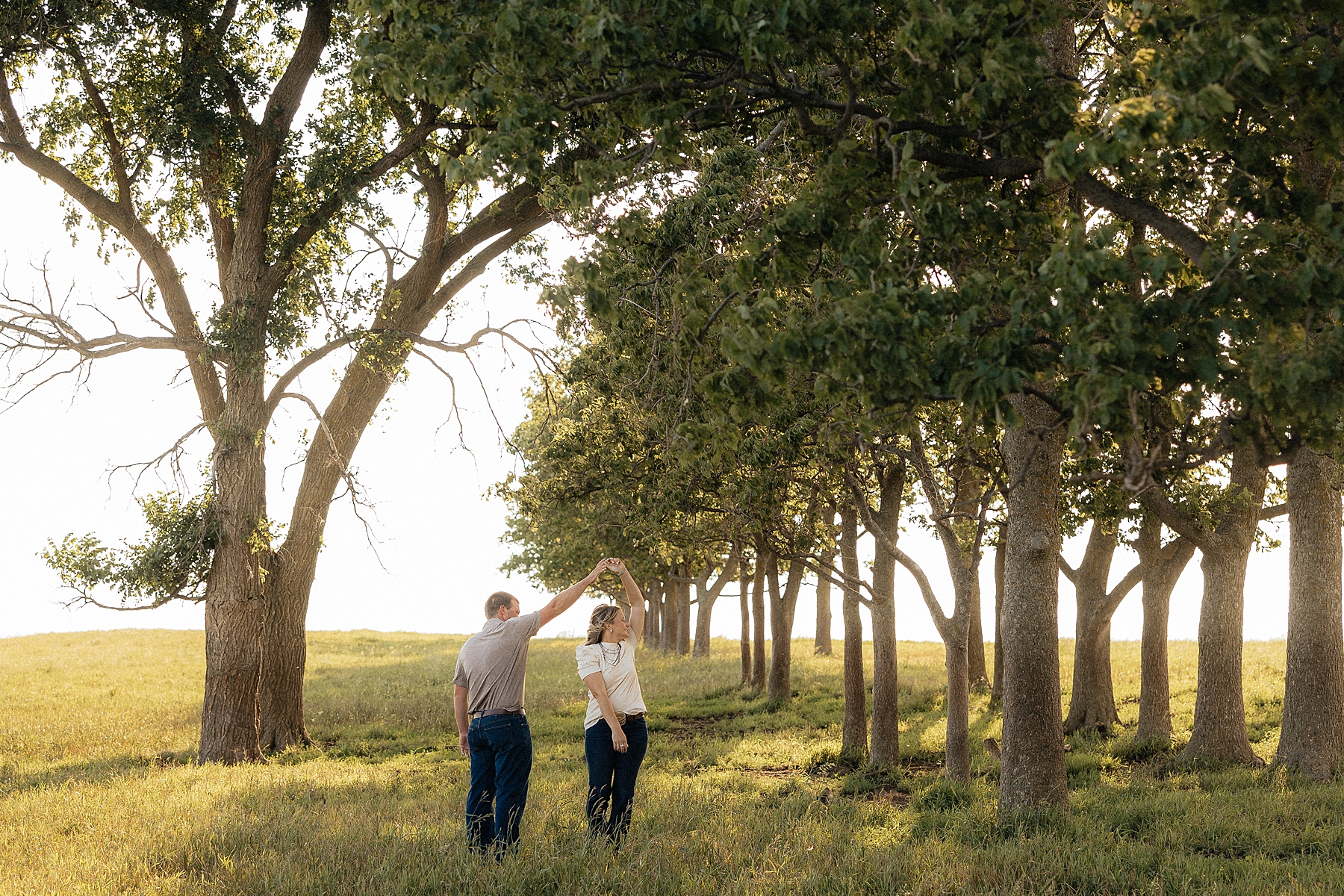 Dylan spinning Lindsey in a field.