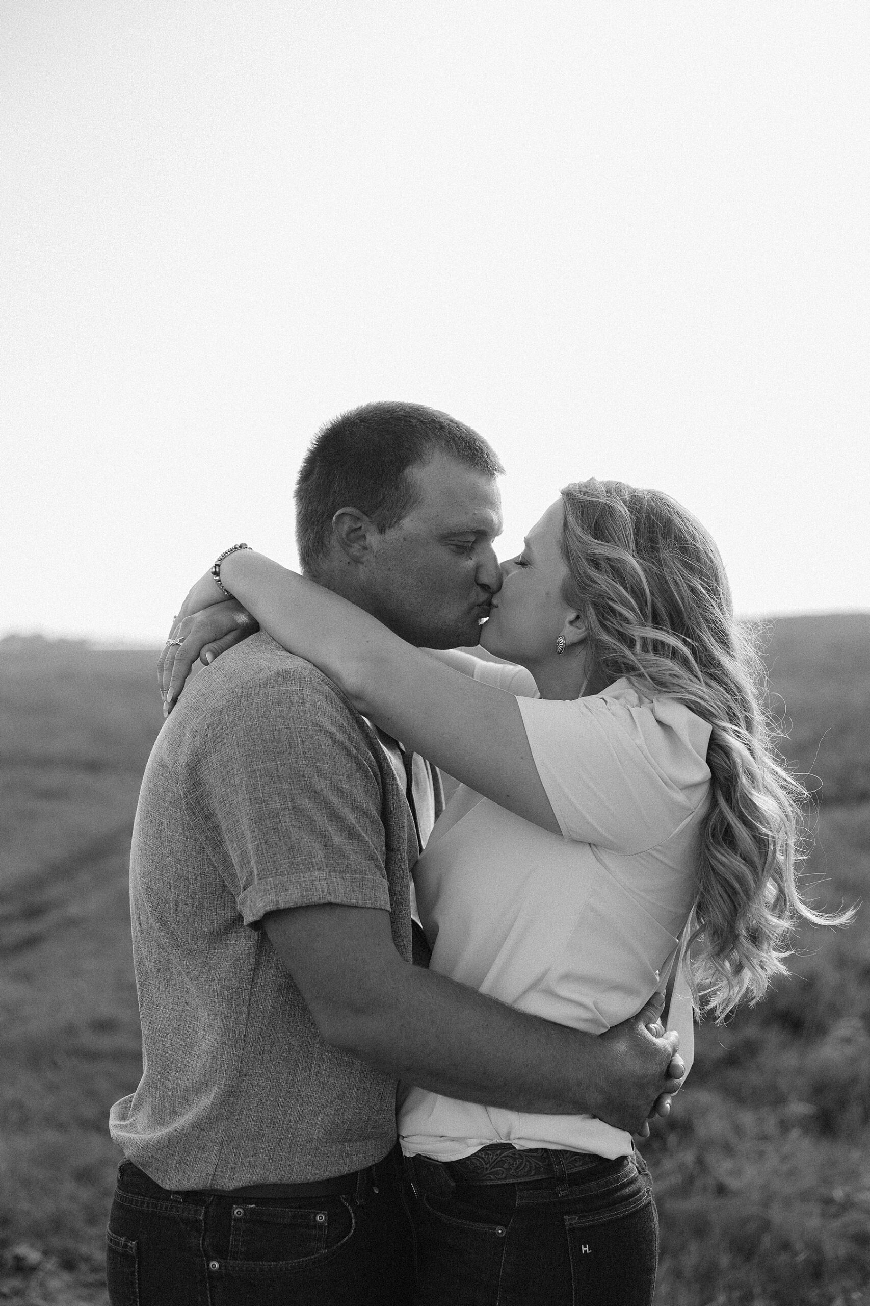 A couple standing in a field.