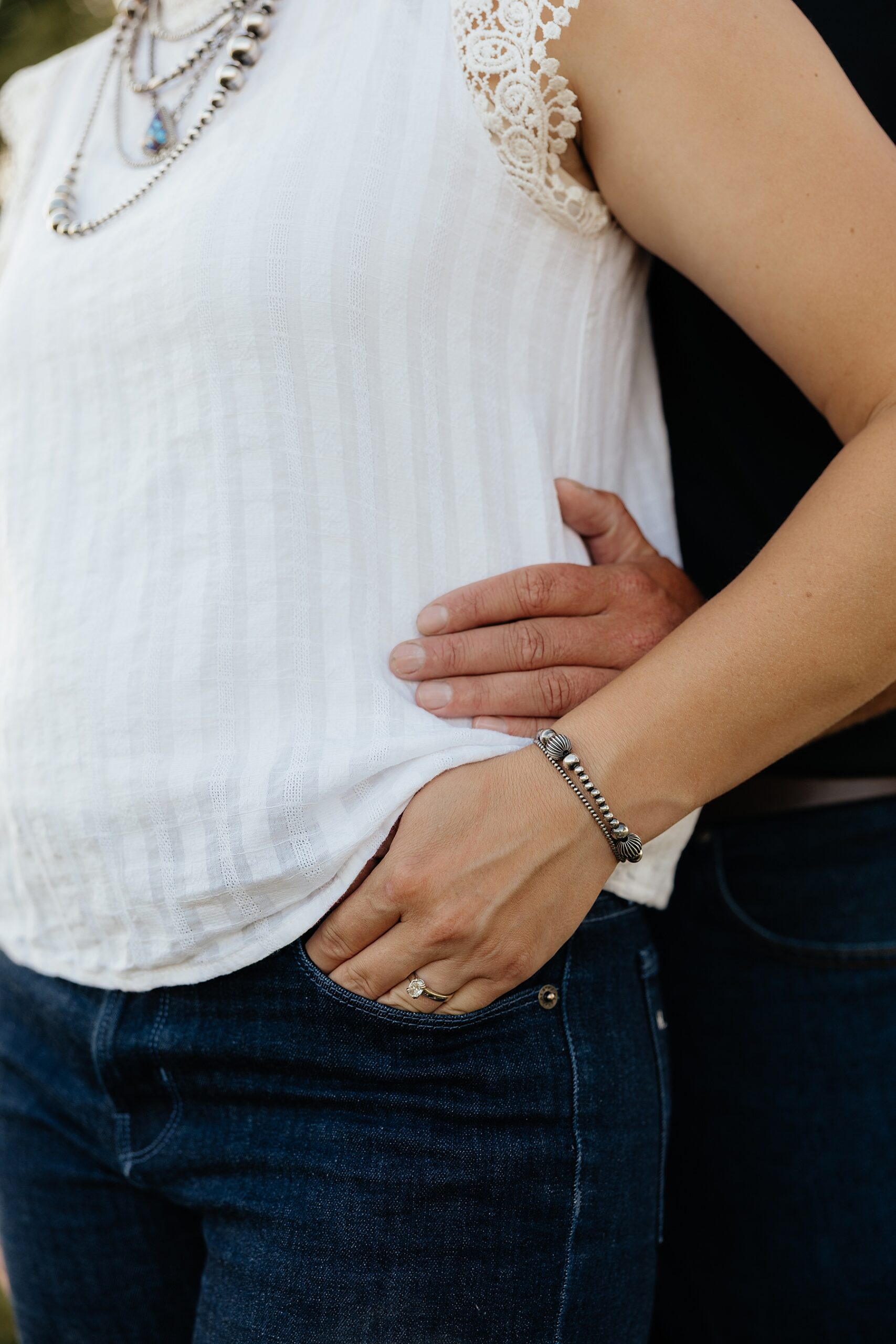 An engagement ring with western pearl bracelets.