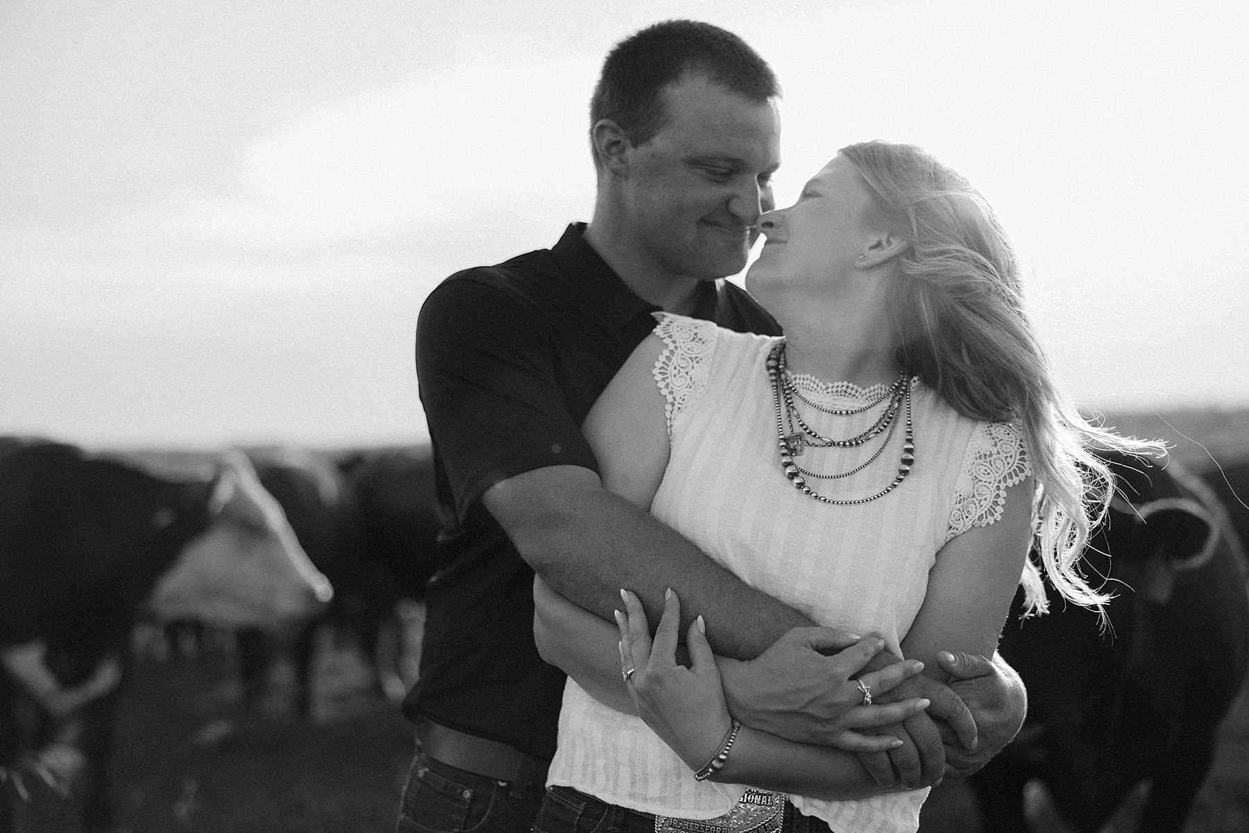 A couple looking at each other in a field.