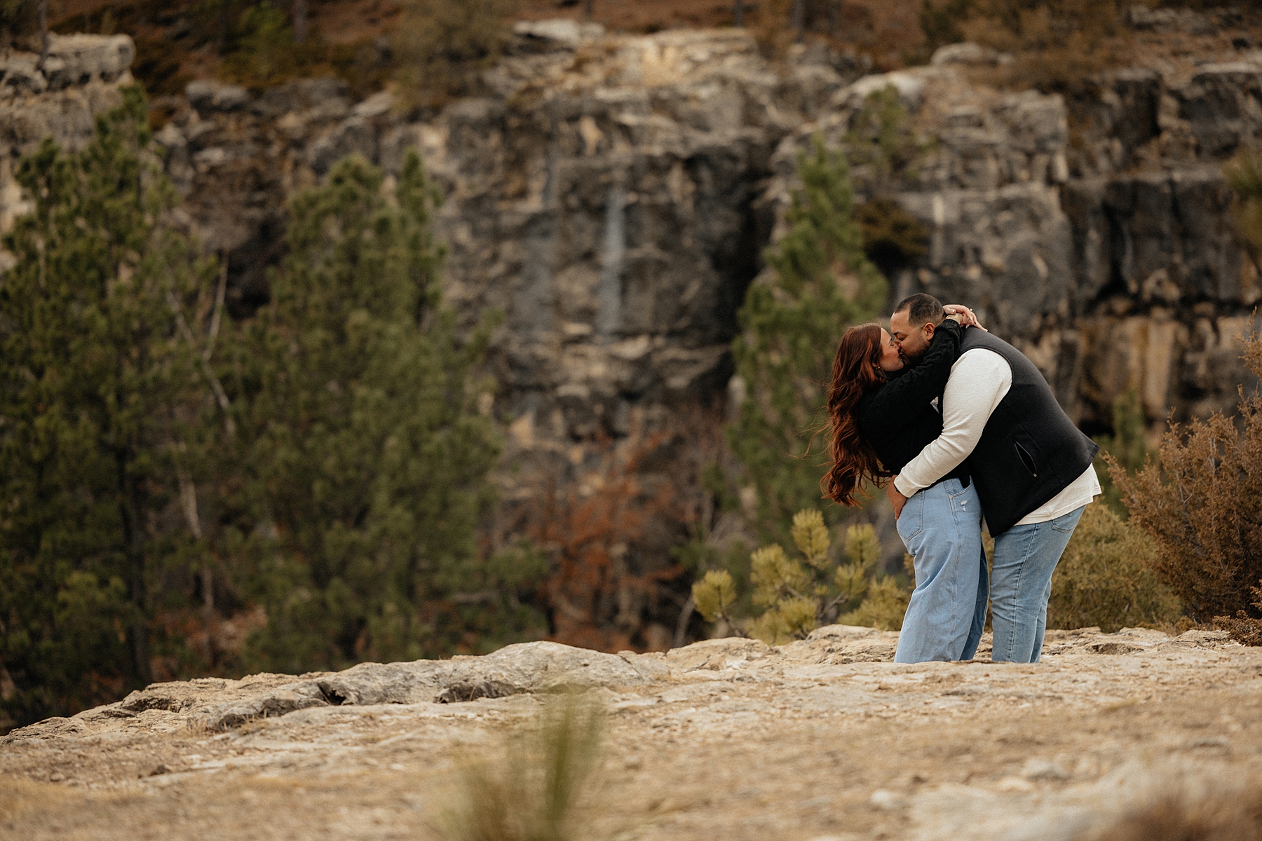 A couple dressed in vests and long sleeves at their outdoor session.