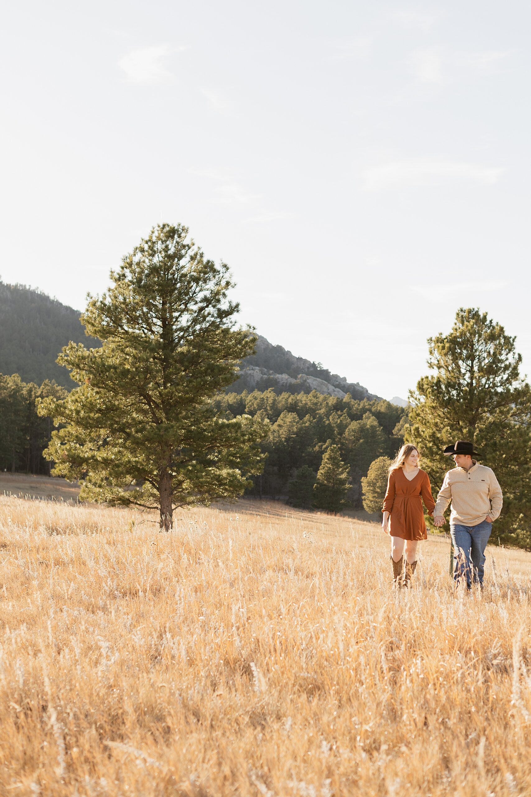 A couple walking in a field in Custer South Dakota.