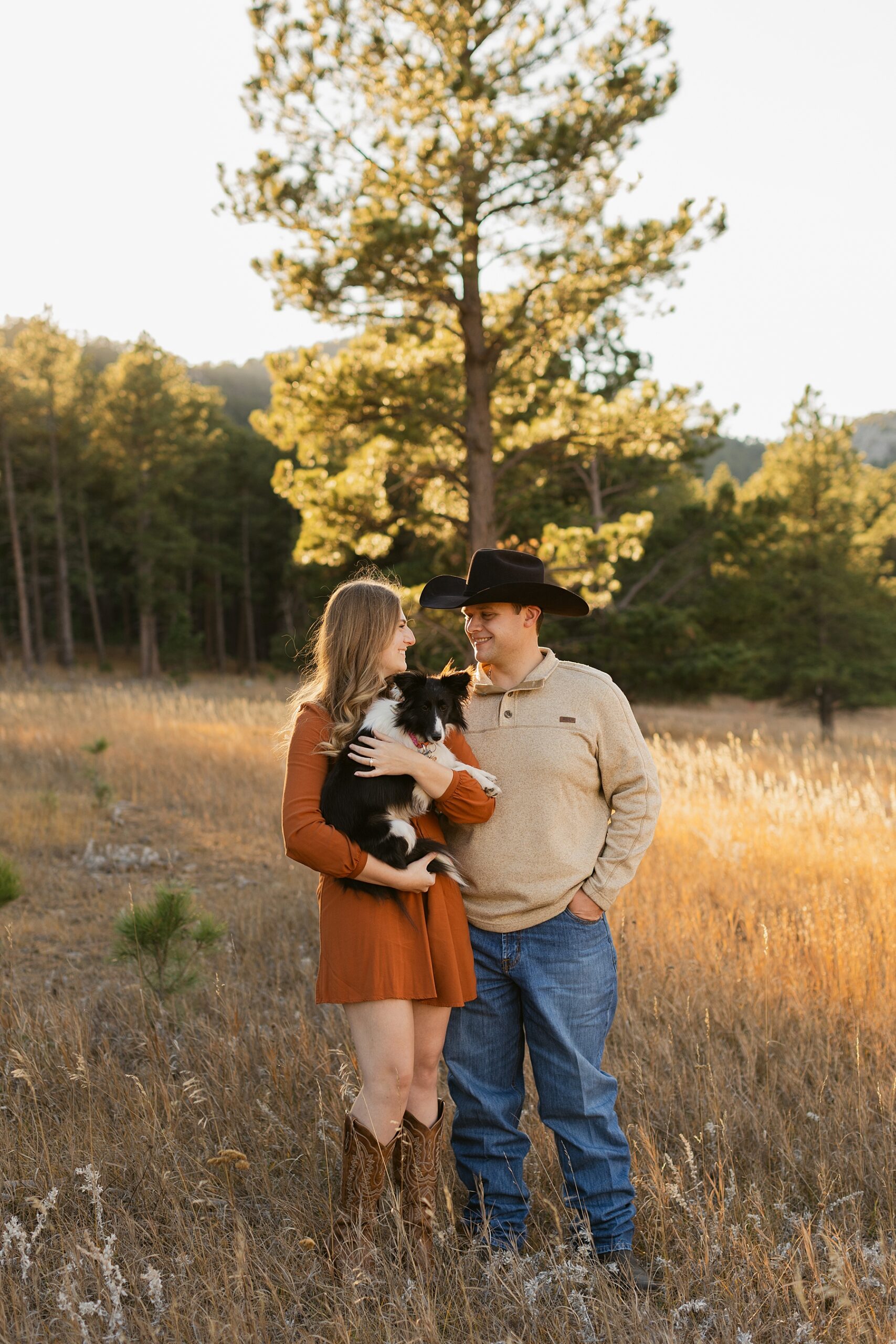 Emma and Jordan with their sheltie dog during their engagement session.