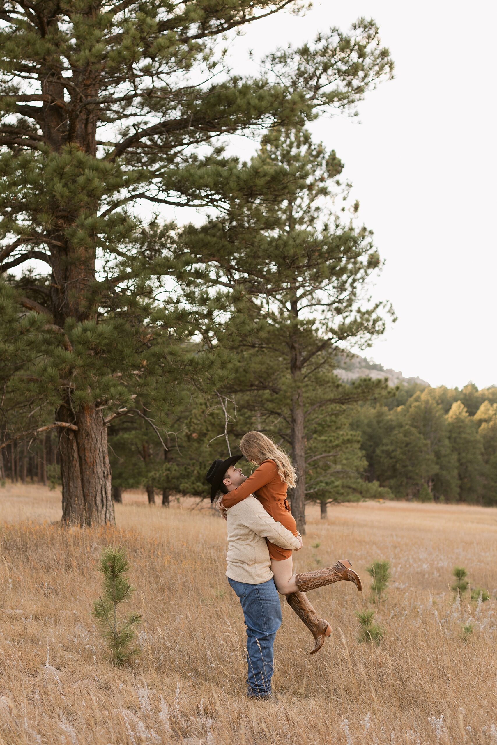 Jordan picks up Emma and spins her around during their engagement session.