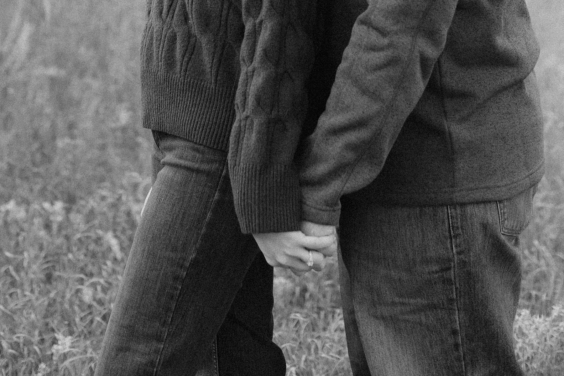 Emma and Jordan holding hands during their engagement session.