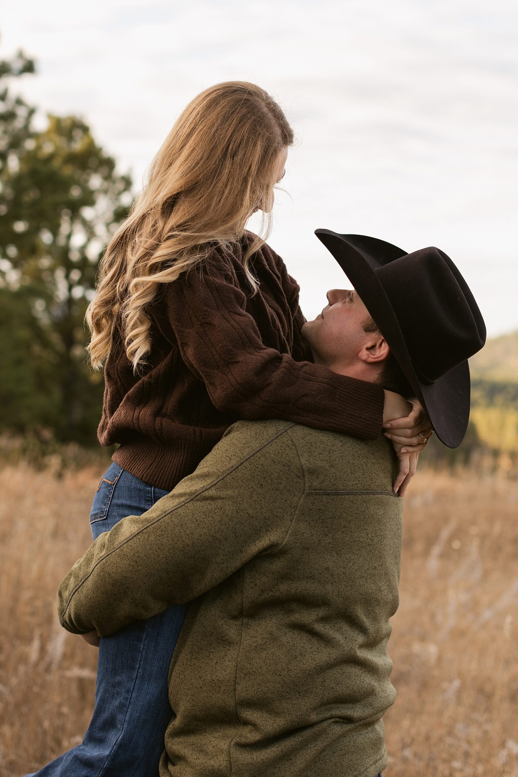 Emma looks down at Jordan while he holds her.