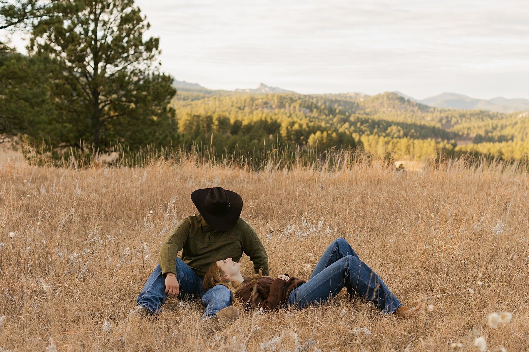 A couple smiling at each other during their engagement session on Iron Mountain Road.
