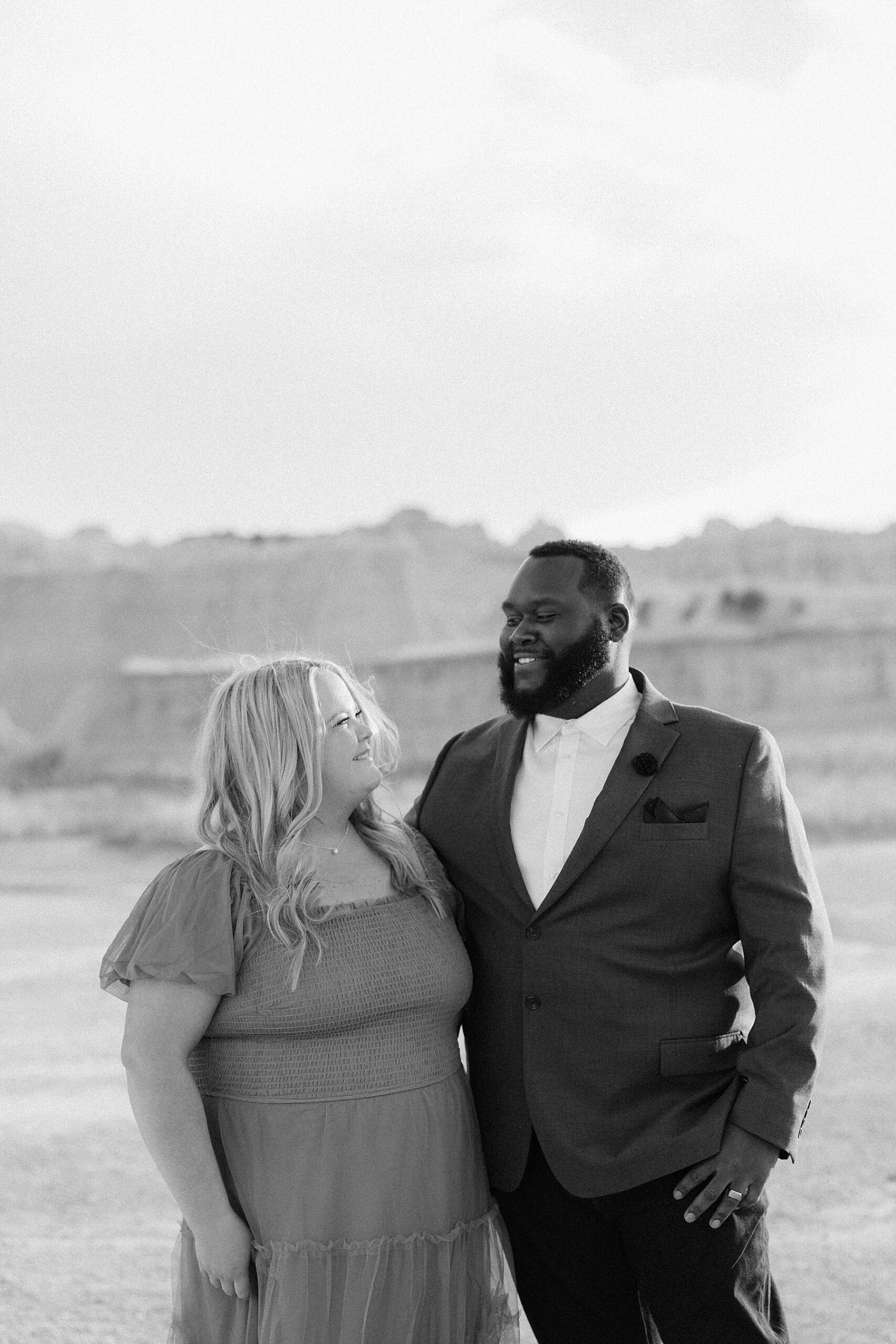 BreAnn and Kenyon smiling at each other in the Badlands.