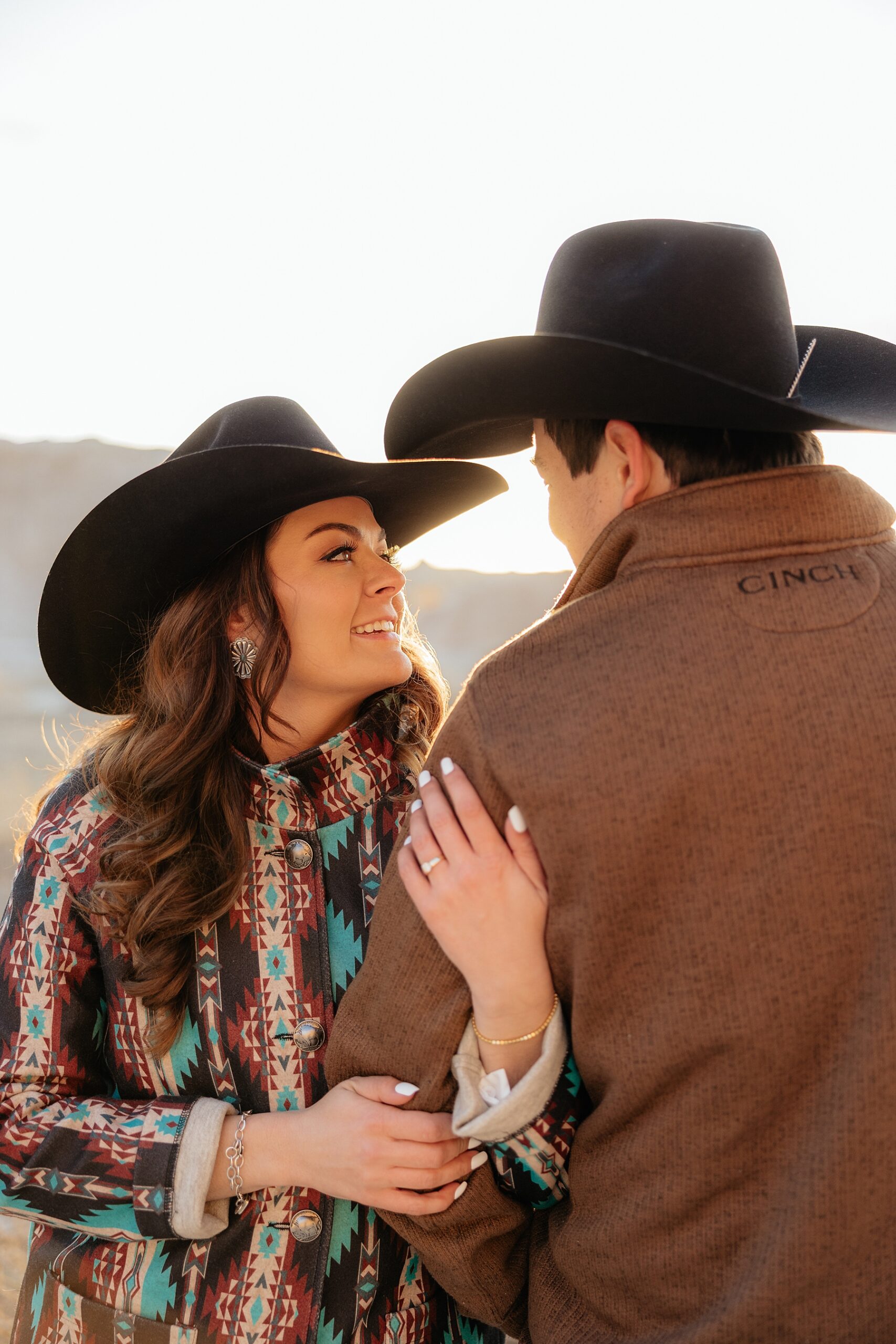 Couple smiling at each other during their badlands engagement session.
