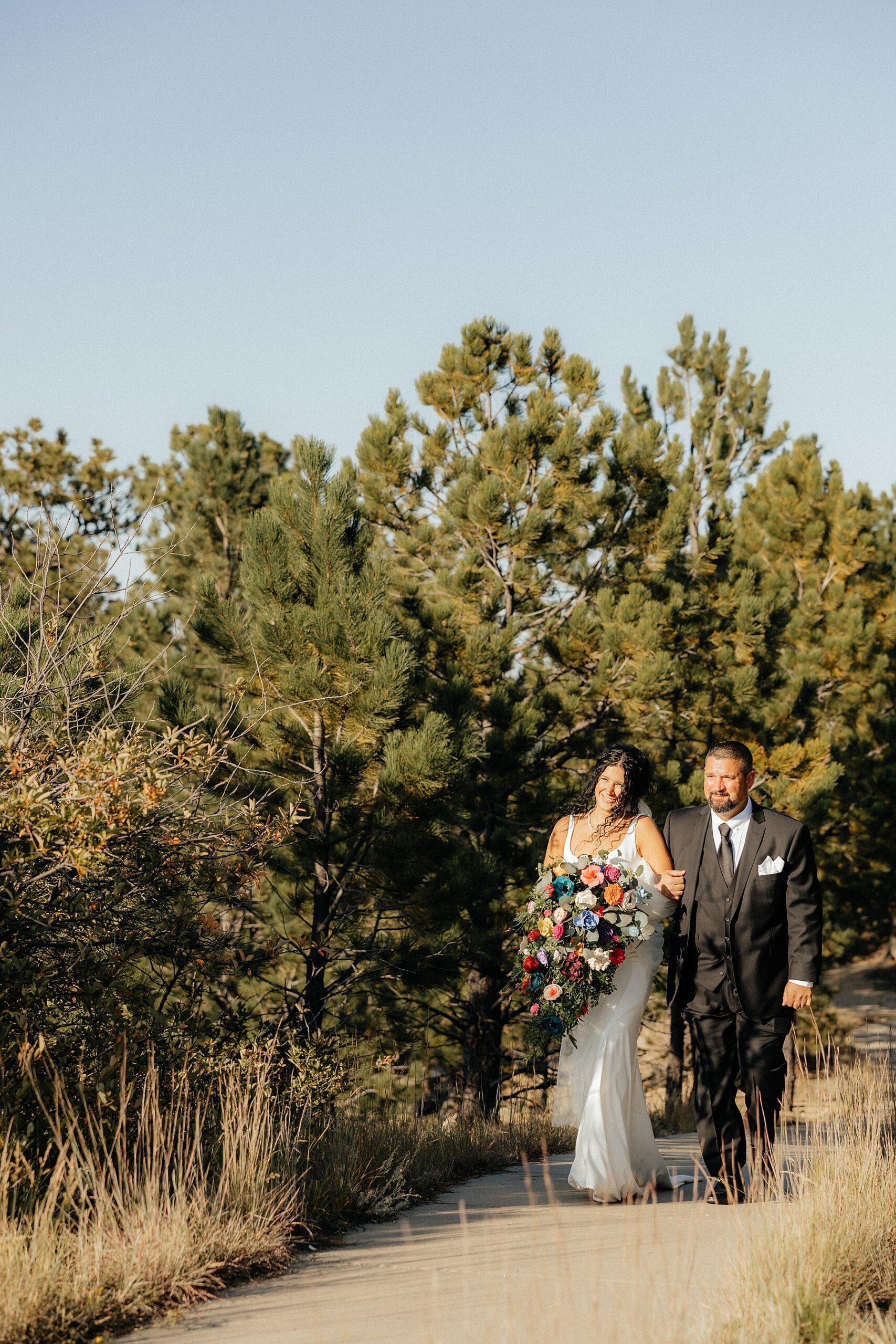 The bride walking up the aisle with her father at Breezy Point Picnic Area.