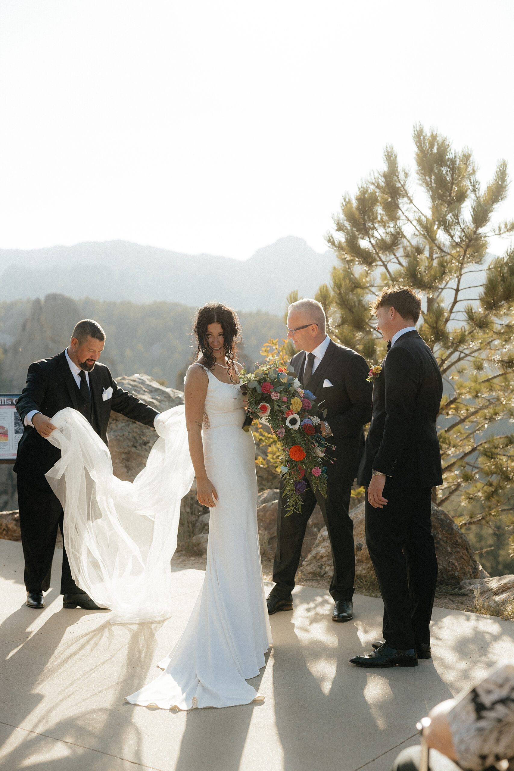 The father of the bride straightening the bride's veil at her Rapid City elopement.