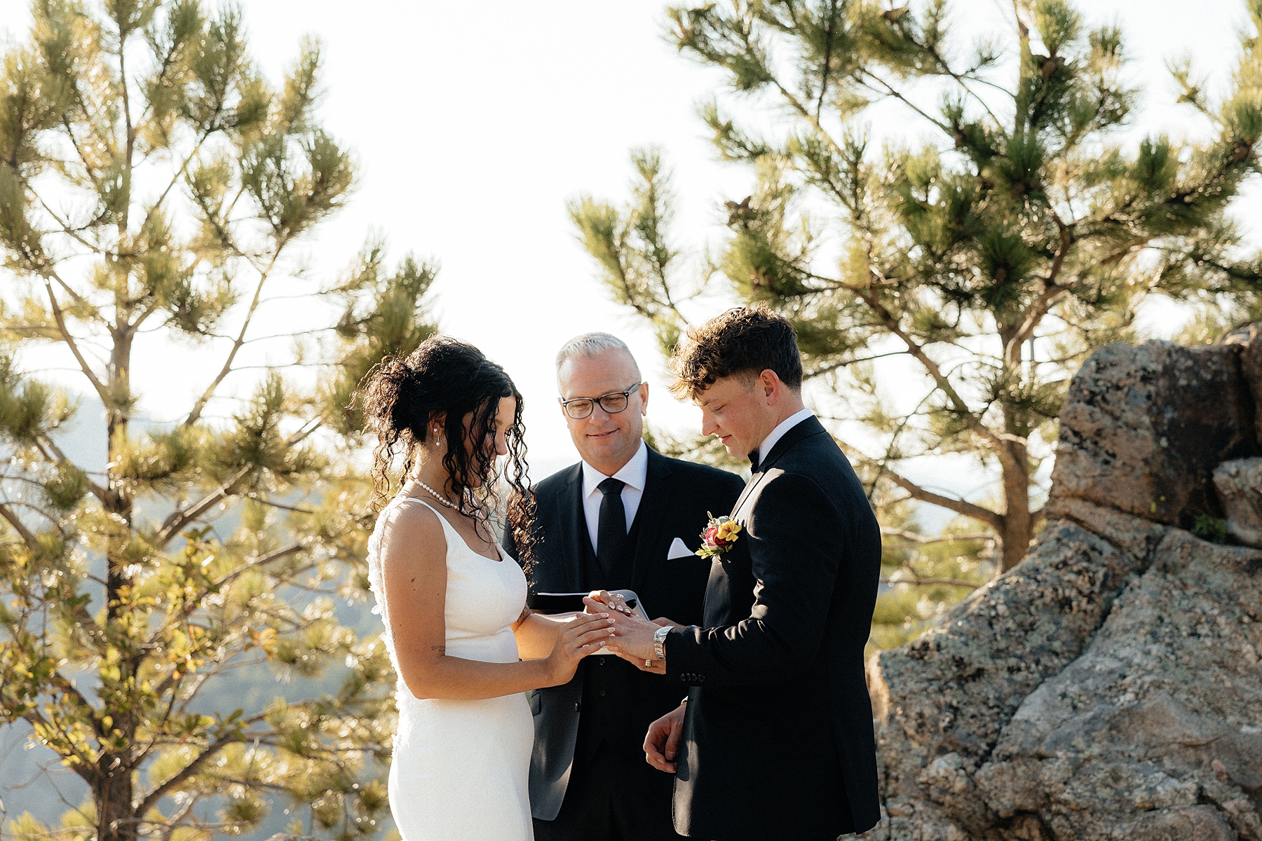 The bride putting the ring on the groom. A Black Hills elopement package.
