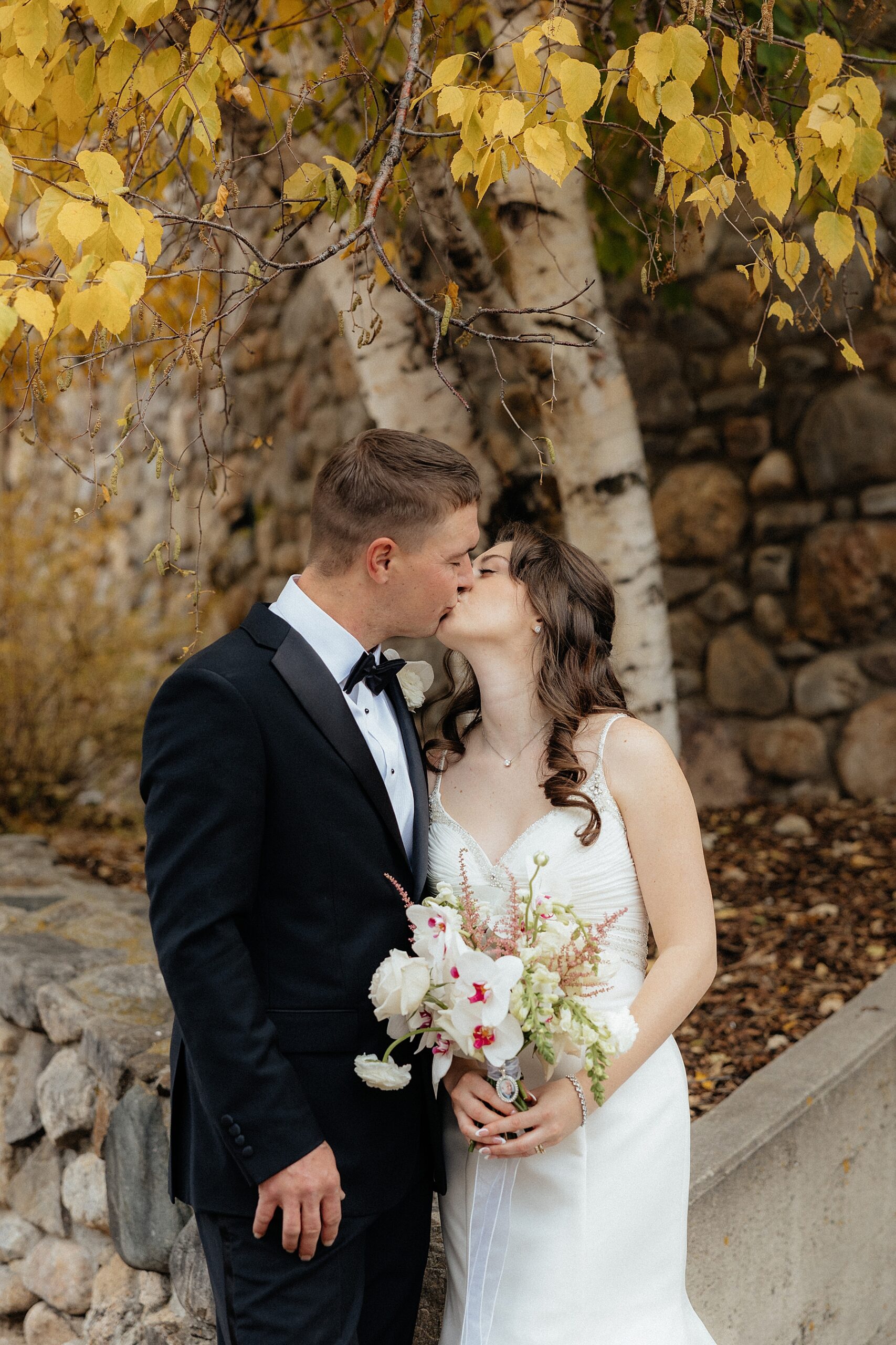 A couple kissing in front of the State Game Lodge.