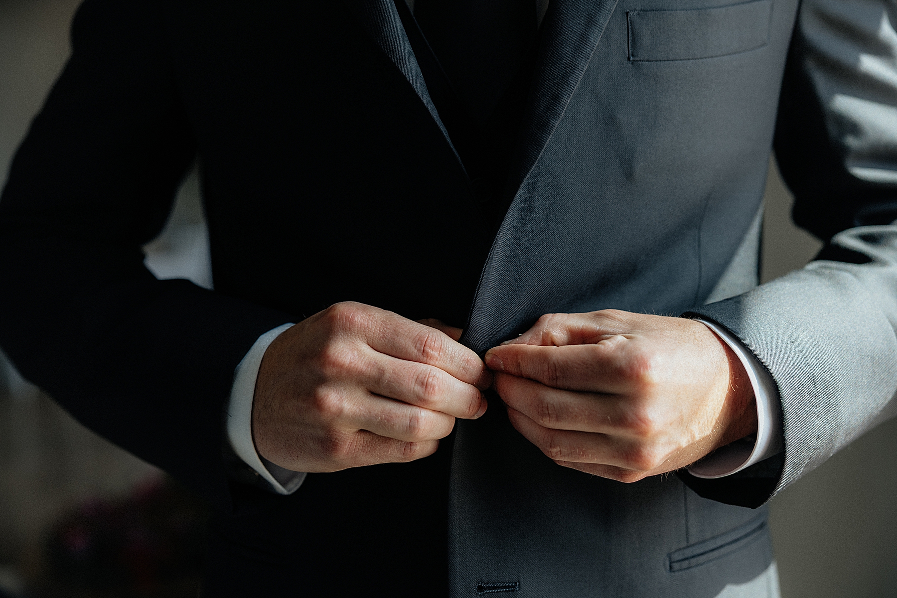 The groom buttoning up his jacket at the Silver Spur Ranch in Belle Fourche, South Dakota.
