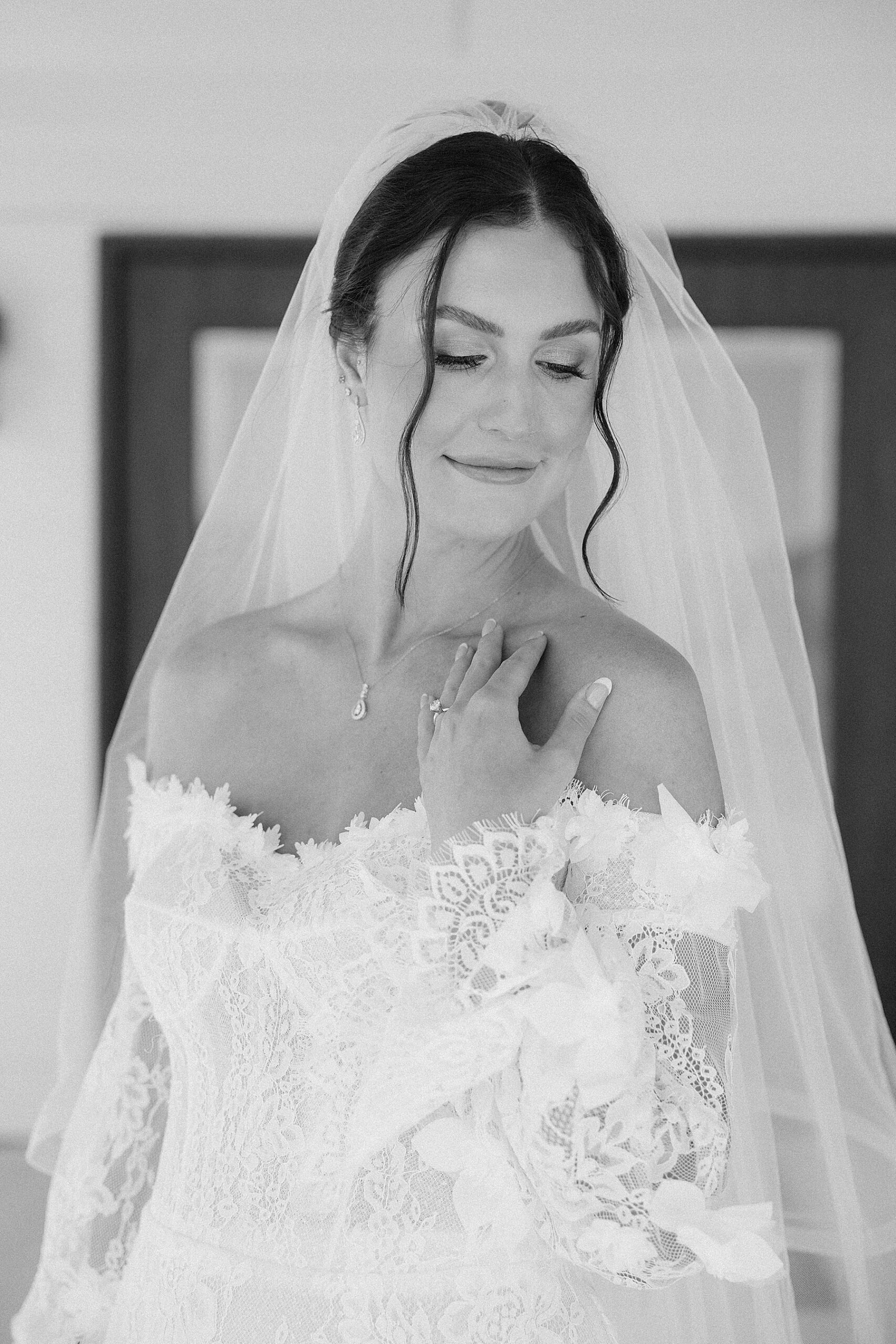 The bride looking softly over her shoulder in her dress at the Silver Spur Ranch in Belle Fourche.