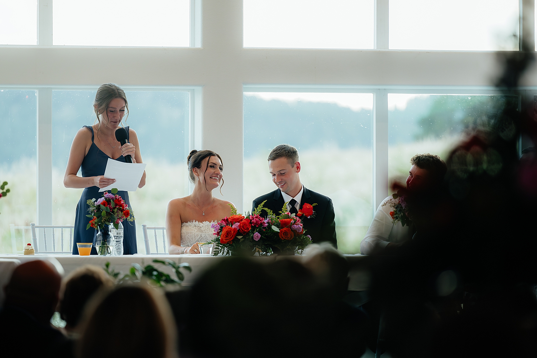 A couple laughing together during speeches.