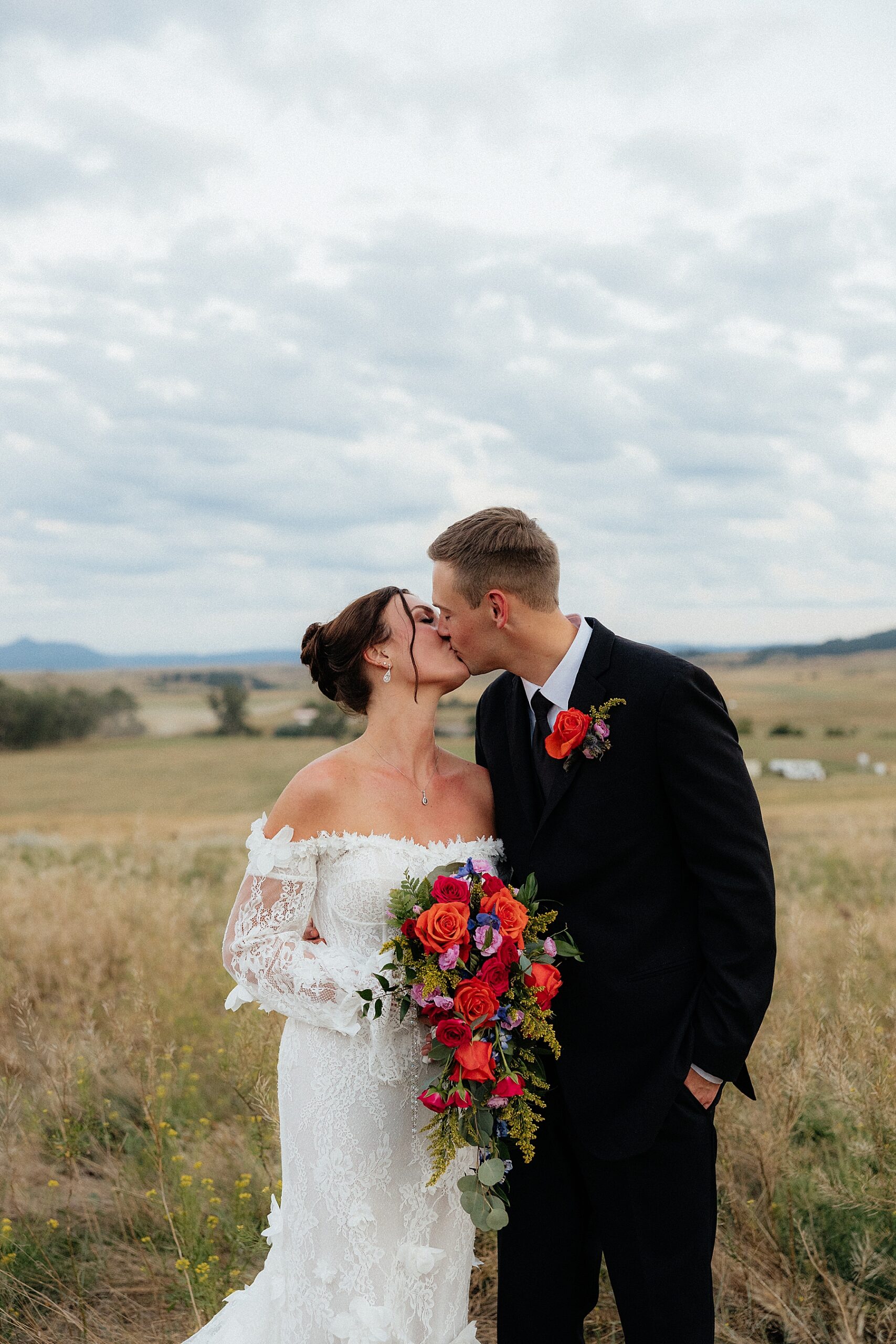 A couple kissing at their Black Hills Wedding at the Silver Spur Ranch.