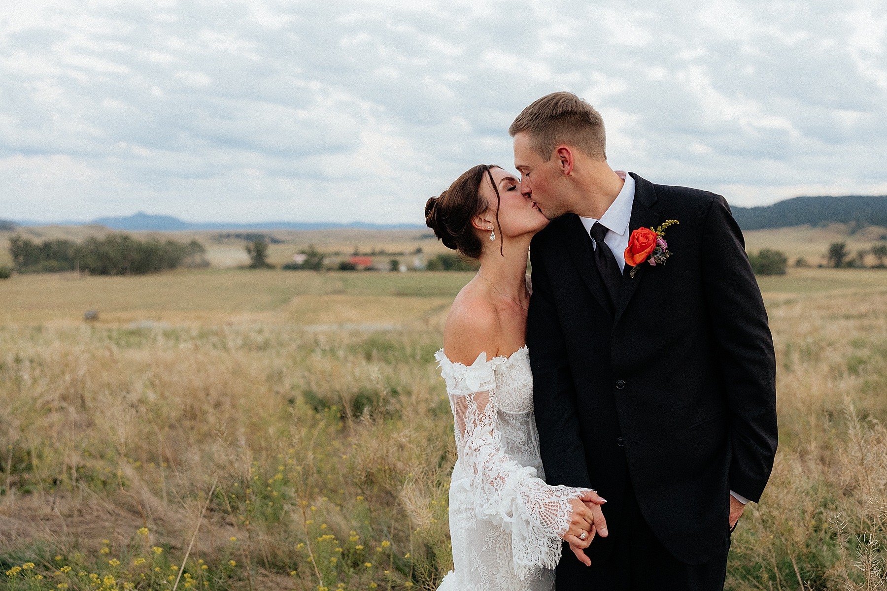 The bride and groom kissing during blue hour at the Silver Spur Ranch. Photo taken by Rapid City Wedding Photographer.