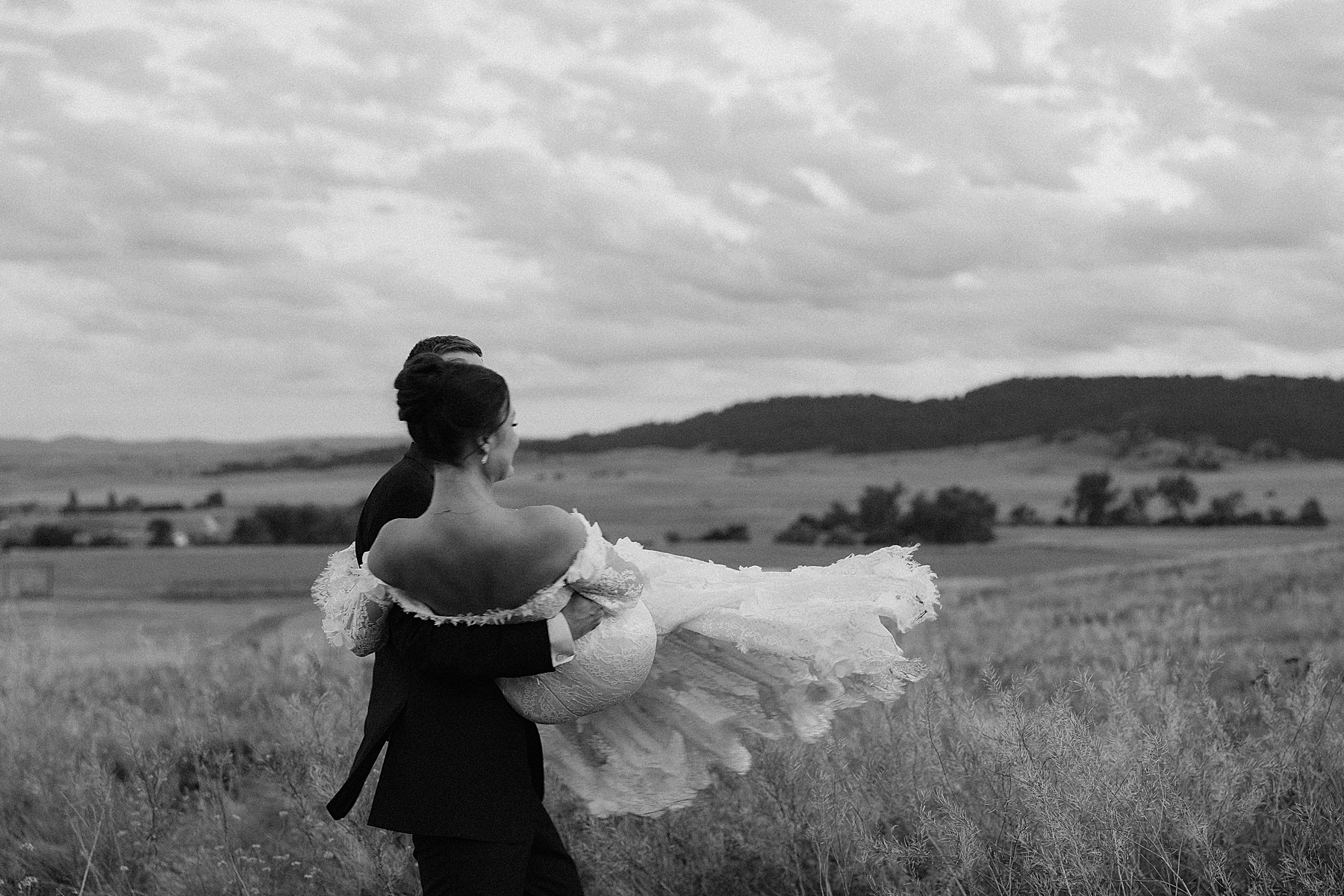 The groom holding his bride and spinning her around.