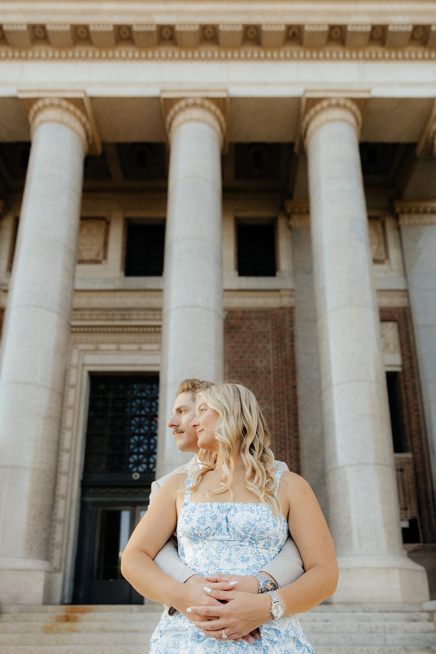 Karissa and Michael standing in front of the courthouse at their creative engagement session.
