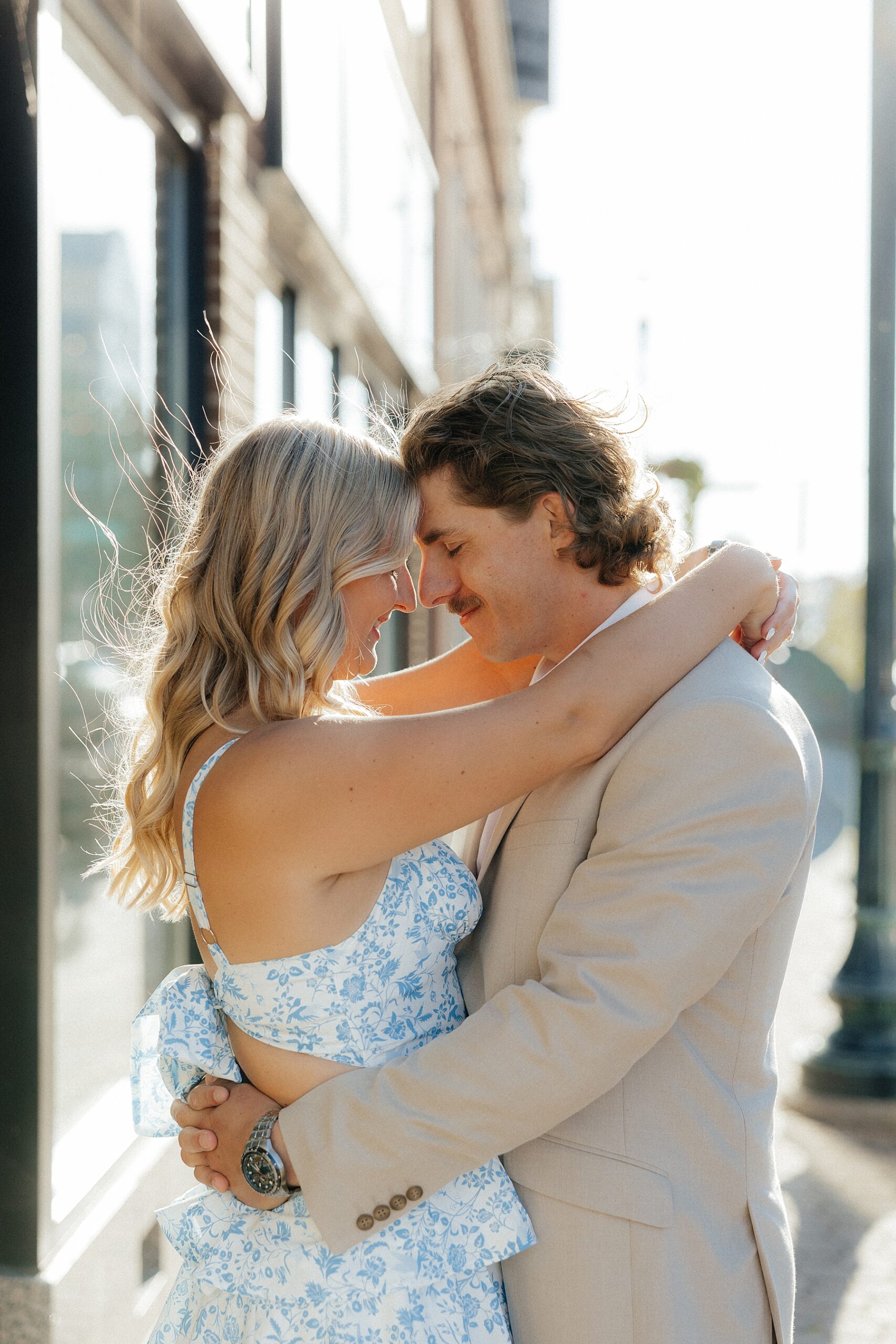 Michael and Karissa standing forehead to forehead in front of The Regency Venue.