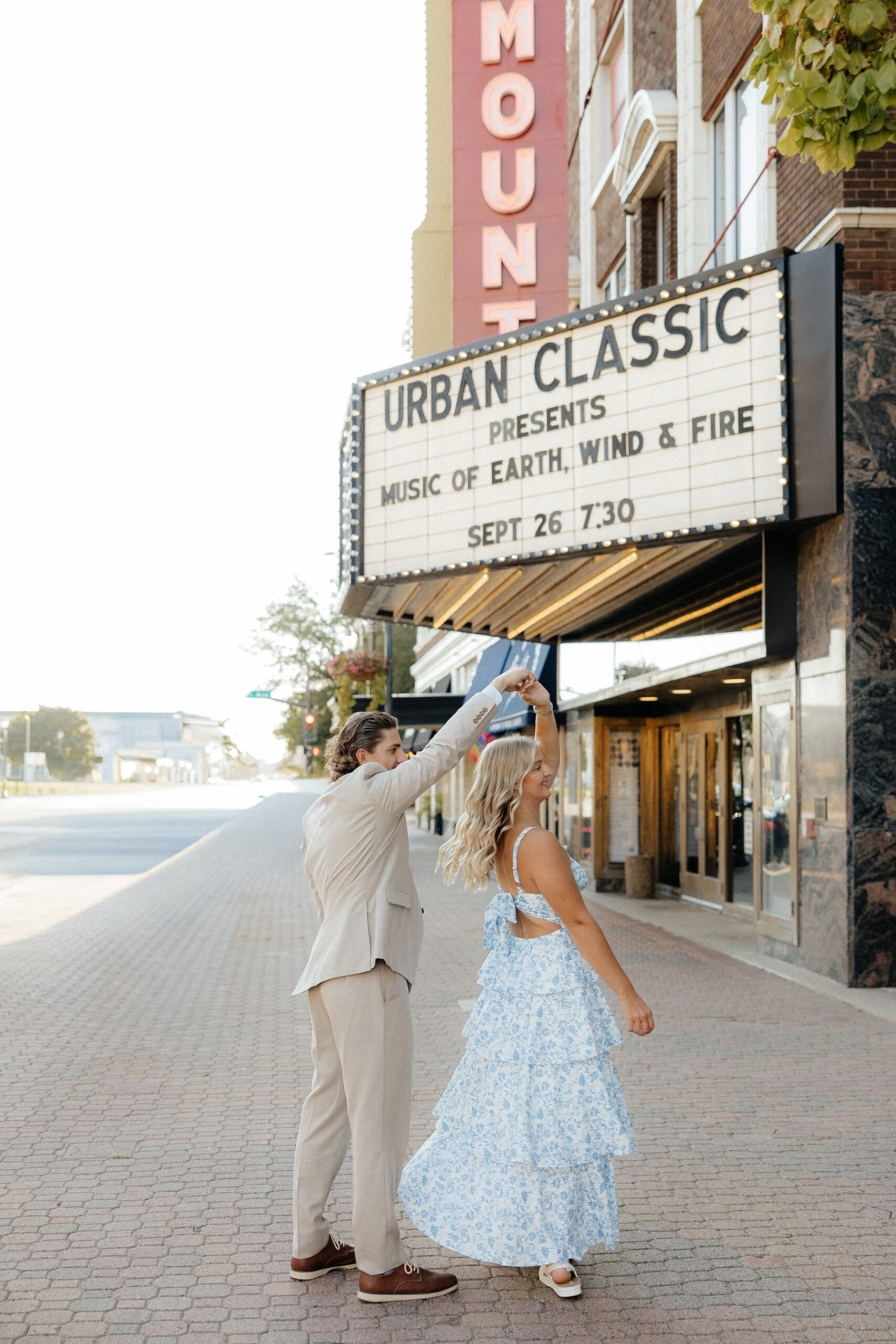 A couple spinning in front of the Paramount Center for the Arts.