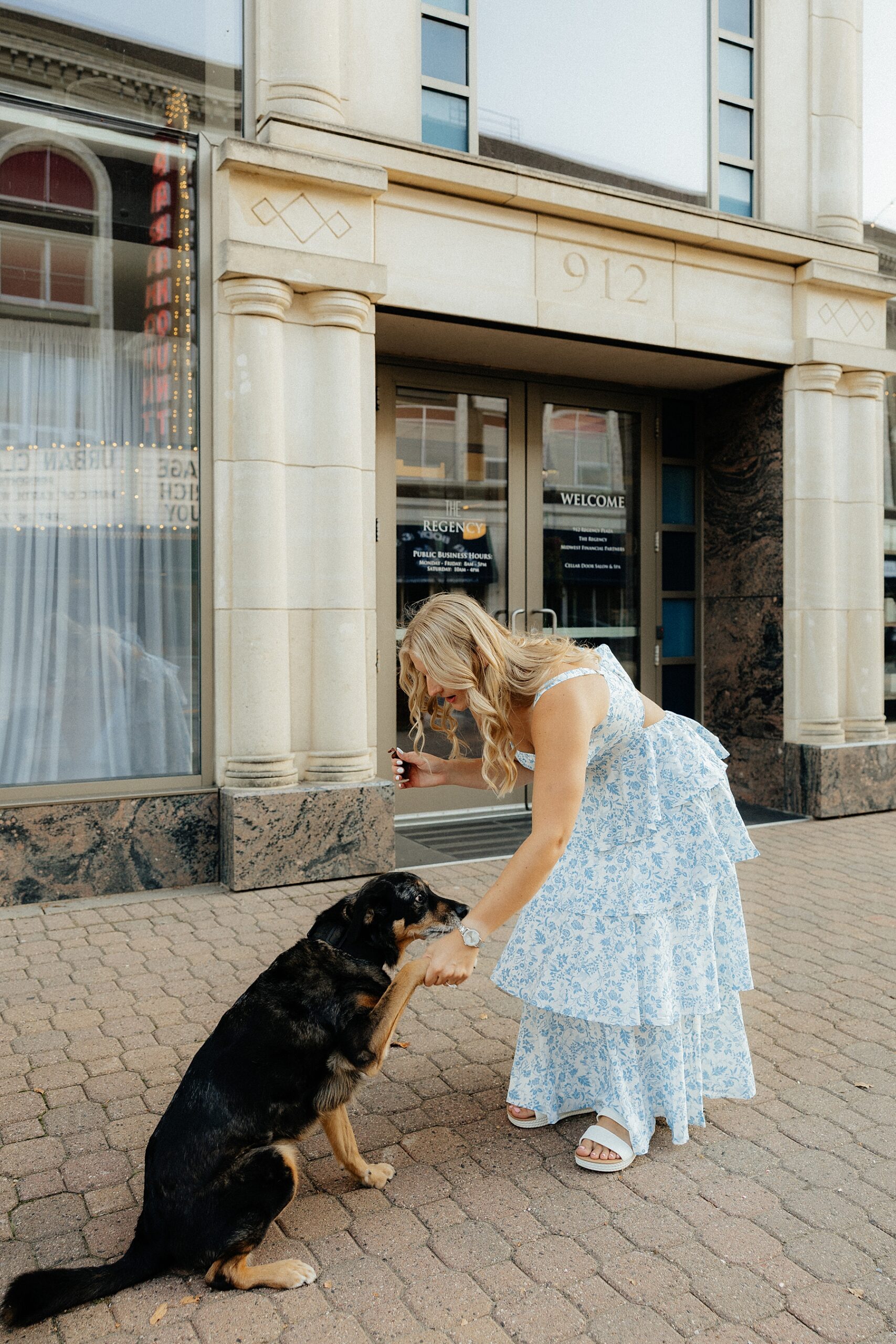 Karissa's dog, Remmy, shakes her paw in front of The Regency.