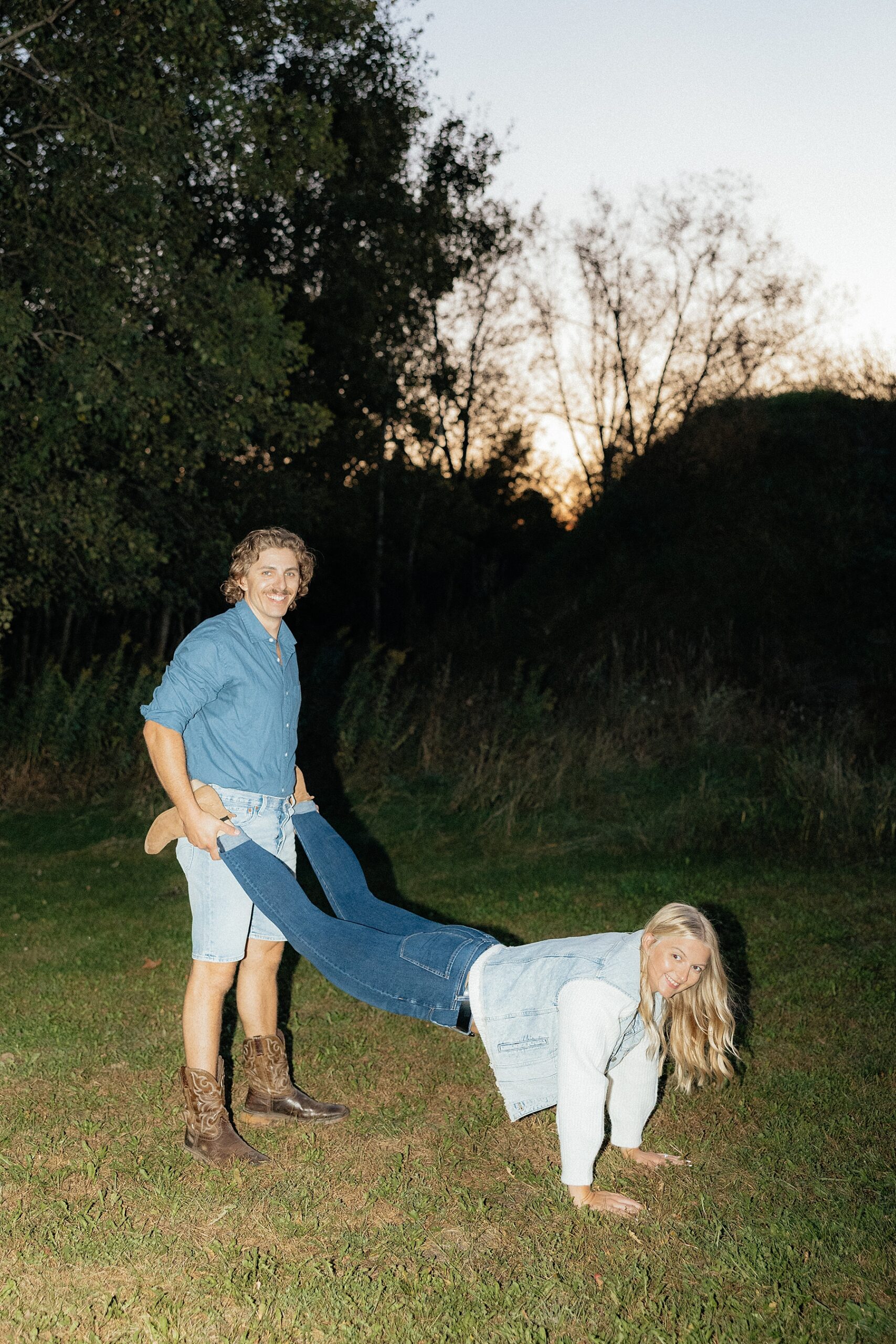 Michael has Karissa in a wheelbarrow position.
