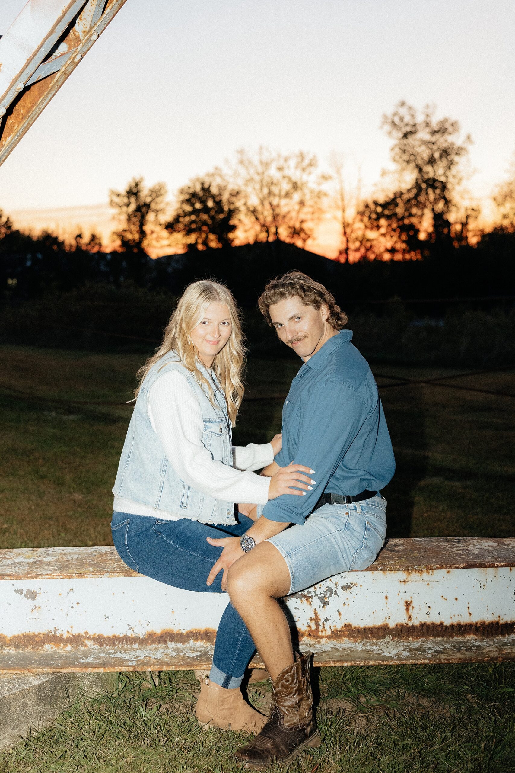 Karrisa and Michael sitting face to face during their goofy engagement session.