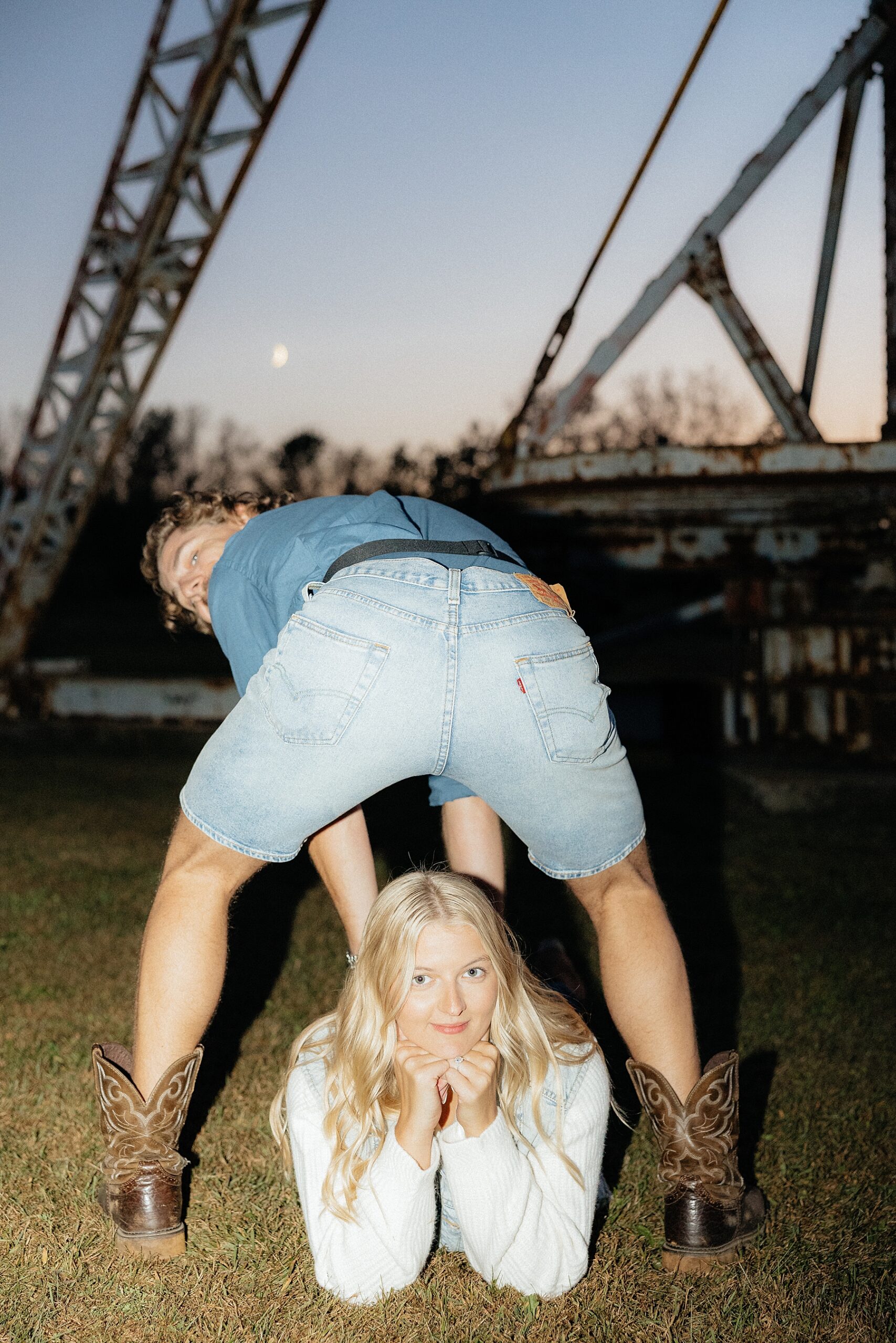 Michael stands over Karissa during their Mastermind inspired section of their engagement photos.