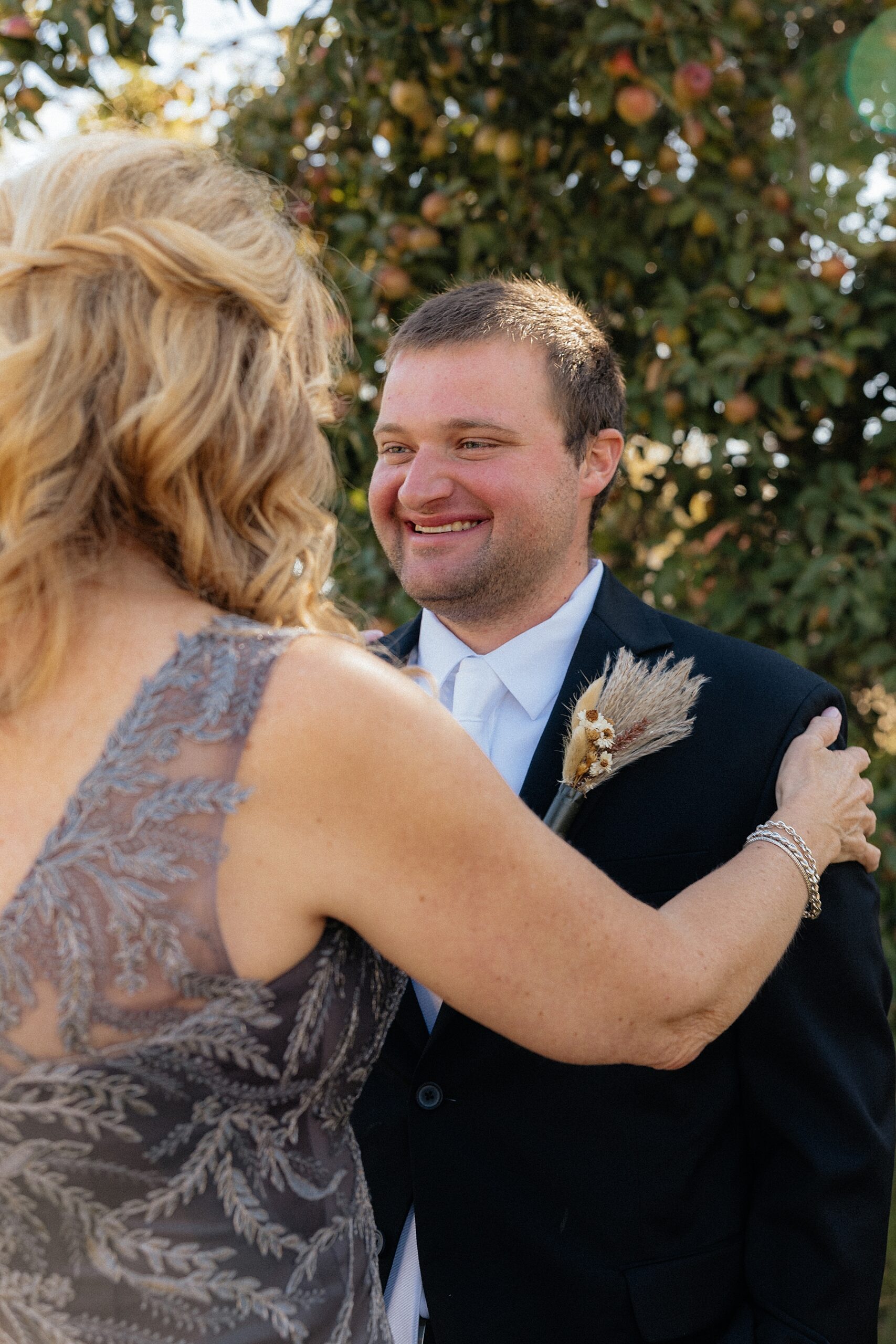 The mother of the groom seeing the groom for the first time.